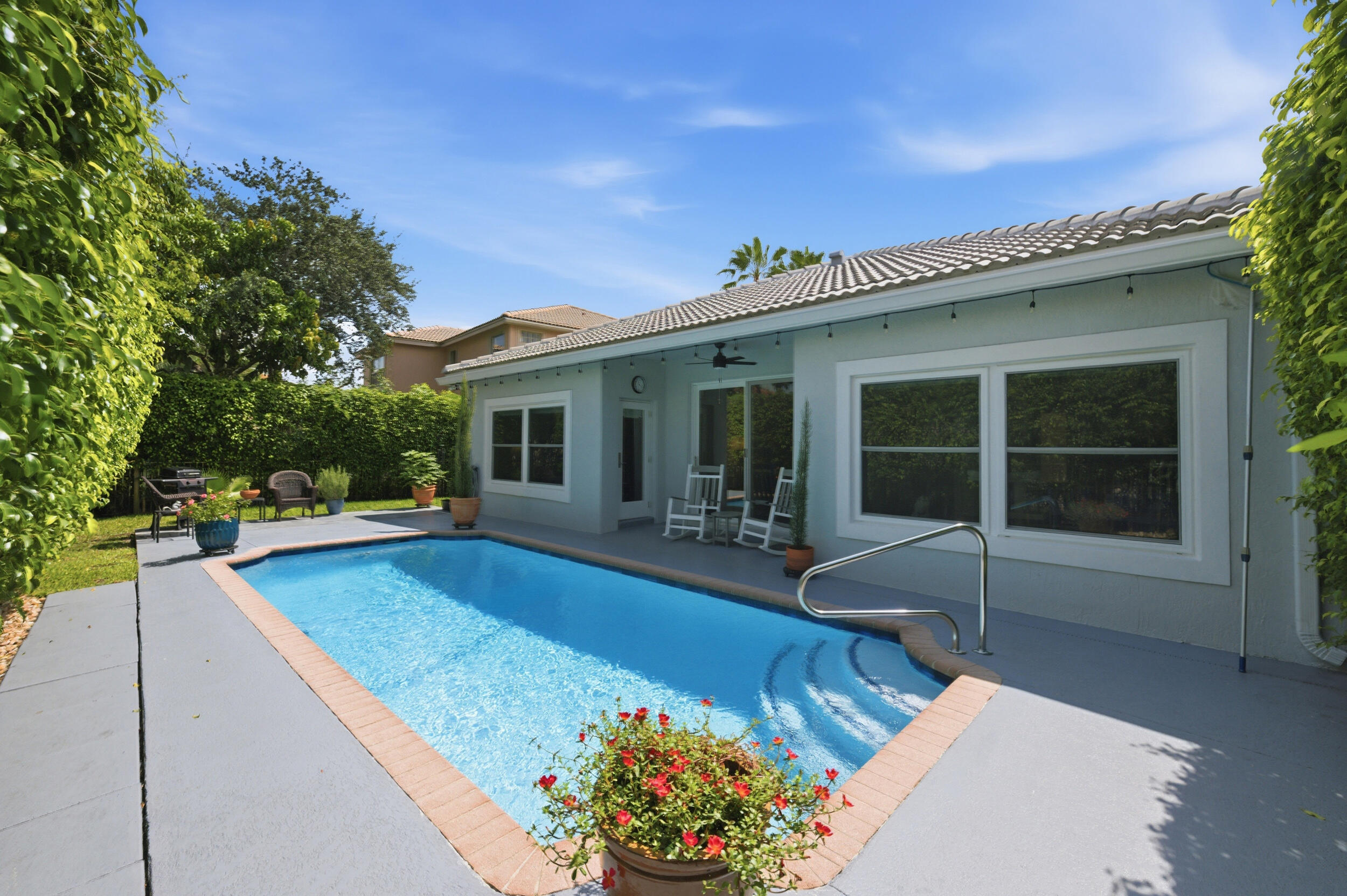 Beautifully updated 4-bed, 2-bath pool home offering the perfect blend of comfort, style, and Florida living! Move-in ready home features a spacious open floor plan. New roof, impact doors and windows, 7" gutters, central A/C and water heater and much more! The private backyard is an entertainer's dream with a sparkling, resurfaced heated pool, with colored LED light and plenty of space to relax or host gatherings. Private fenced-in yard cane toad protection and large side yard for kids and pets. Additional highlights include Luxury vinyl plank flooring, 6" wood double stepped baseboards in every room and closet. Freshly painted in and out. 2 car garage. Gated community. Located in a top-rated school district near shopping, dining, parks, and major highways. Some furniture AI enhanced.