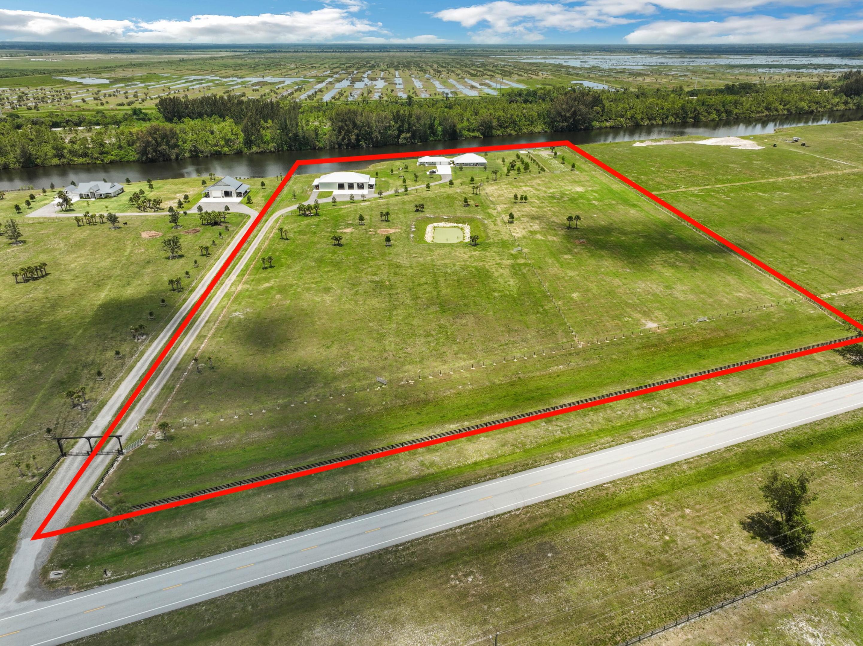 Luxury meets functionality on this 20.8 acre waterfront compound. 2022 CBS home boasting 4 beds, 3.5 baths, a separate 1 bed guest home, 6,000 Sq. Ft. detached shop, and agricultural zoning for 19.8 acres. Inside the main home discover 3,150 sq ft of modern living space with coffered ceilings, custom cabinets, and plantation shutters. The kitchen impresses with a Thermador gas range, quartz countertops, and ample storage. The primary suite offers multiple closets and a spa-like bathroom. A 999 sq ft guest home ensures comfort, while a breezeway connects the main house, garage, and guest home. 100' x 60' Detached shop with 5 garage doors. Embrace outdoor charm and endless possibilities on this expansive property. Additional Details:
2022 Metal roof, 2022 CBS build, Ag zoning, 6,000 Sq Ft detached shop with office and 5 14' electric garage doors, boat dock & lift being installed, 2021 generator and owned 1,000 gal propane, Impact doors and windows throughout, 2 gas instant hot water in main house, electric water heater in guest house, 3 A/C units (2 main house, 1 guest house), fire sprinklers in main and guest house, hardwired camera security system (7 cameras), Sonos speakers in both patios, solid wood doors & cabinets, LVP flooring.