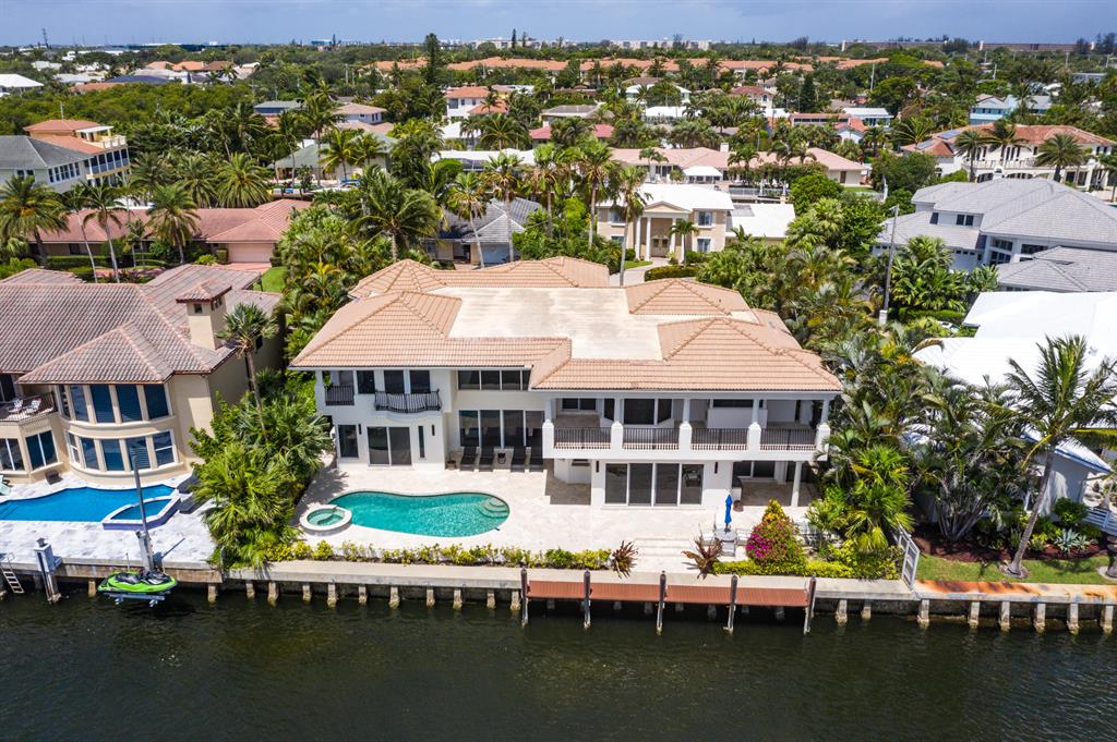 Located on a quiet cul de sac at 5600 Coastal Drive in Boca Raton, this 4 bedroom 4.1 bathroom estate encompasses 7,100 total square feet of boater's paradise on the intracoastal waterway. A circular driveway dotted with lush, mature landscaping invites you into the double doored entrance, accented by custom stained glass windows. Through the doors and into the foyer, you are wowed by the stream of natural light that pours through countless impact glass windows and doors and bounces off the high ceilings and marble floors. The wide open floor plan offers views of the intracoastal from the spacious living room, dining room, and recently renovated chef's kitchen. Up the wooden beamed stairs is the expansive second floor master suite, equipped with its own balcony that overlooks wide water views. Other luxurious amenities of this home include a pool and spa situated next to the intracoastal, an elevator, and dock with ocean access. 
 
Caribbean Keys is an exclusive waterfront community nestled in the eastern part of Boca Raton. Minutes from downtown Delray, Gulf Stream, Ocean Ridge, and Highland Beach, and just a short drive away from Palm Beach Island, this desirable neighborhood offers unmatched privacy and access to the best that South Florida has to offer.