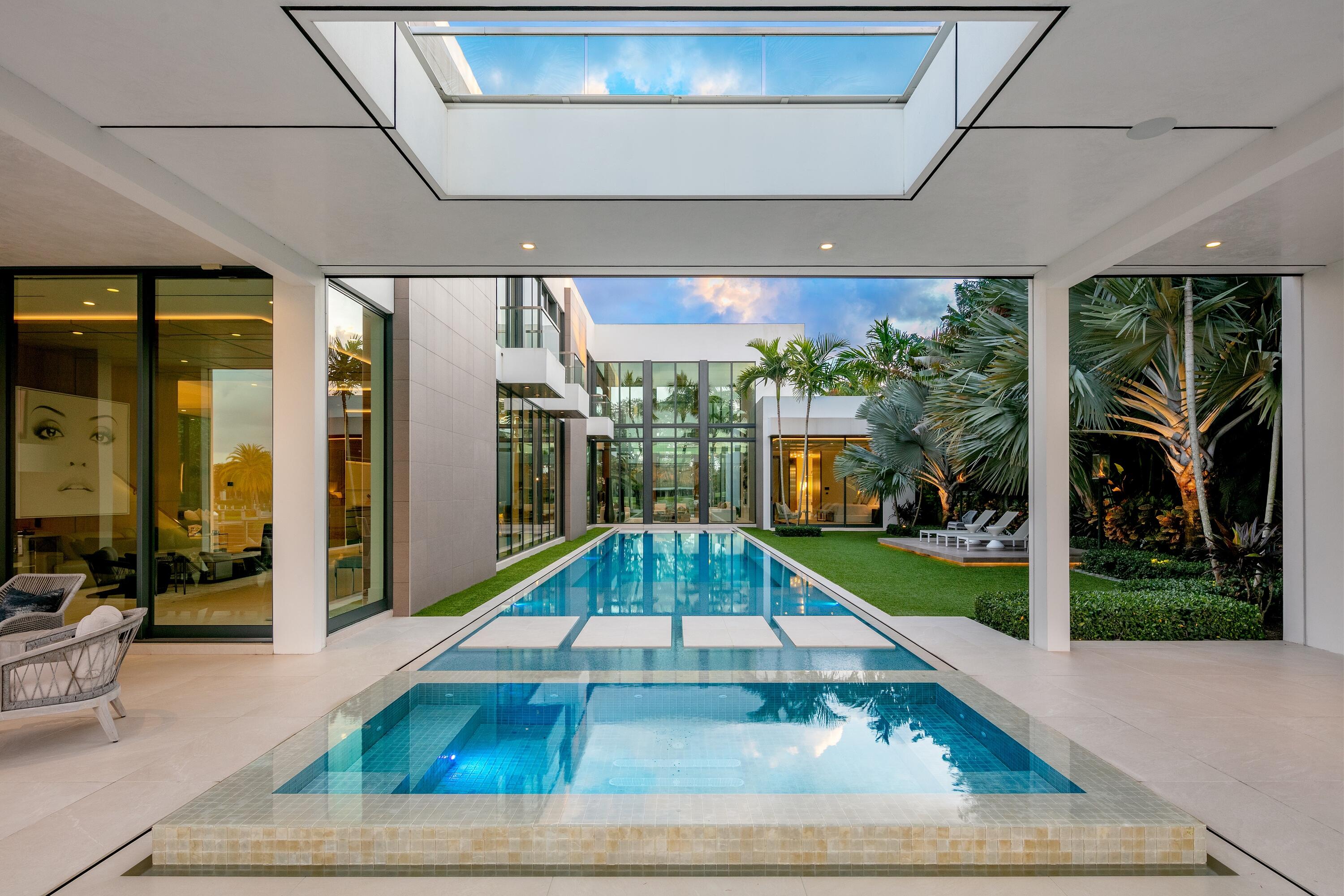 Welcome to 160 Spyglass Ln, a remarkably contemporary waterfront estate nestled among the elegance of Jupiter's coveted Admiral's Cove. Masterfully designed by Affiniti Architects, intricate stone & wood finishes accentuate the home throughout, perfectly complementing its 23-foot ceilings, pristine glass façades and spacious living areas. Inside, lavish first-floor master & guest suites give way to luxurious highlights including state-of-the-art Crestron home automation & designer appliances, a gourmet chef's kitchen & custom wine vault. Outside, the estate's defining sky deck overlooks its sophisticated spaces below, including a pool & spa w/ full cabana, designer summer kitchen and 100 feet of pristine, protected dockage w/ partial Intracoastal waterfront views - a true boater's delight.