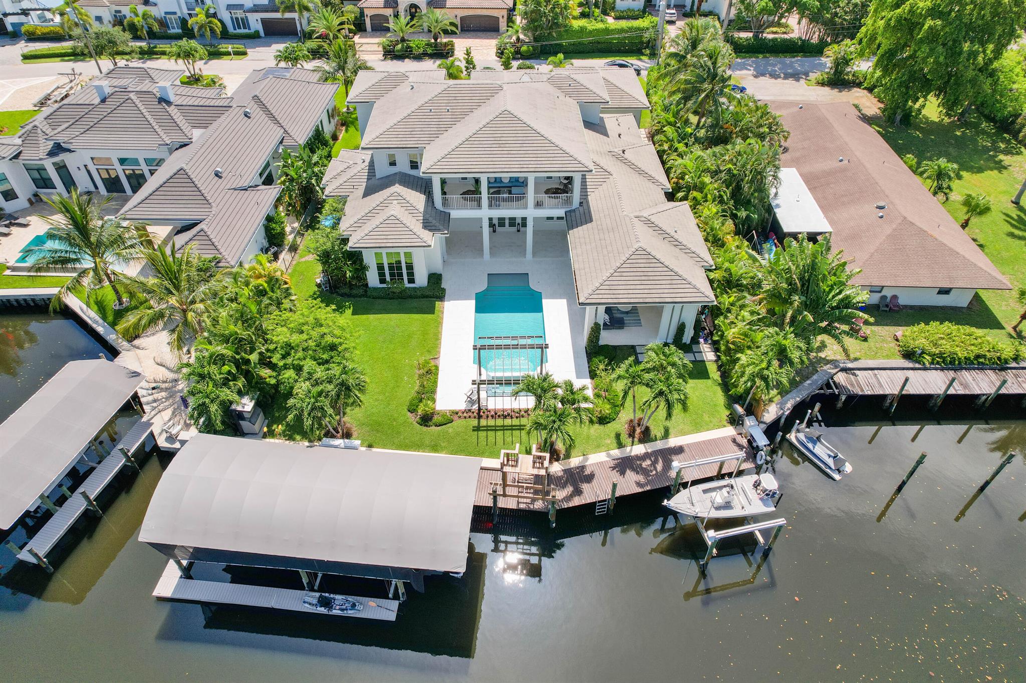 NEWER WATERFRONT ESTATE BY HOBGOOD CONSTRUCTION. Built in 2019, this home has become a fisherman's paradise! Full 1-car garage transformed into a bait and tackle room, 110 LF of waterfront, open dock space and boathouse! 21K and 16K lifts plus 600lb ice maker! Enjoy a relaxing pool oasis with tranquil waterfall from the pergola. Custom floor plan offers water views from nearly every living space. Grand two-story foyer, formal living room with gas fireplace and views of the pool, true chef's kitchen with double islands, Thermador appliances and hidden pantry plus a casual family room looking out to the entertaining area. Spacious lower level master suite with expansive water views, wet bar with beverage cooler, luxurious master bath with walk-through shower and ample closet space.