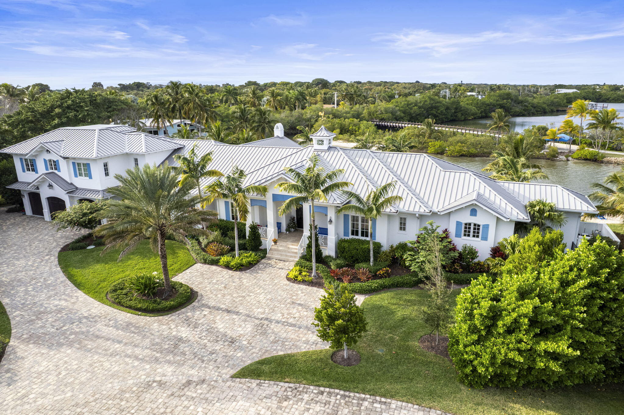 2020 Built waterfront masterpiece with brand new attached, but separate, guest quarters. Almost 7,000 sq ft of air-conditioned luxury situated at the end of a cul-de-sac on a point lot offering 340 ft of waterfront. Spectacular lagoon views and protected dockage. New sea wall installed when home was built. 2 existing lifts will accommodate boats under 40' feet in length. Oversized 3 car garage. Incredible outdoor pool area & hot tub overlooking the blue/green Indian River Lagoon. No bridges blocking your access to the river or Atlantic Ocean.