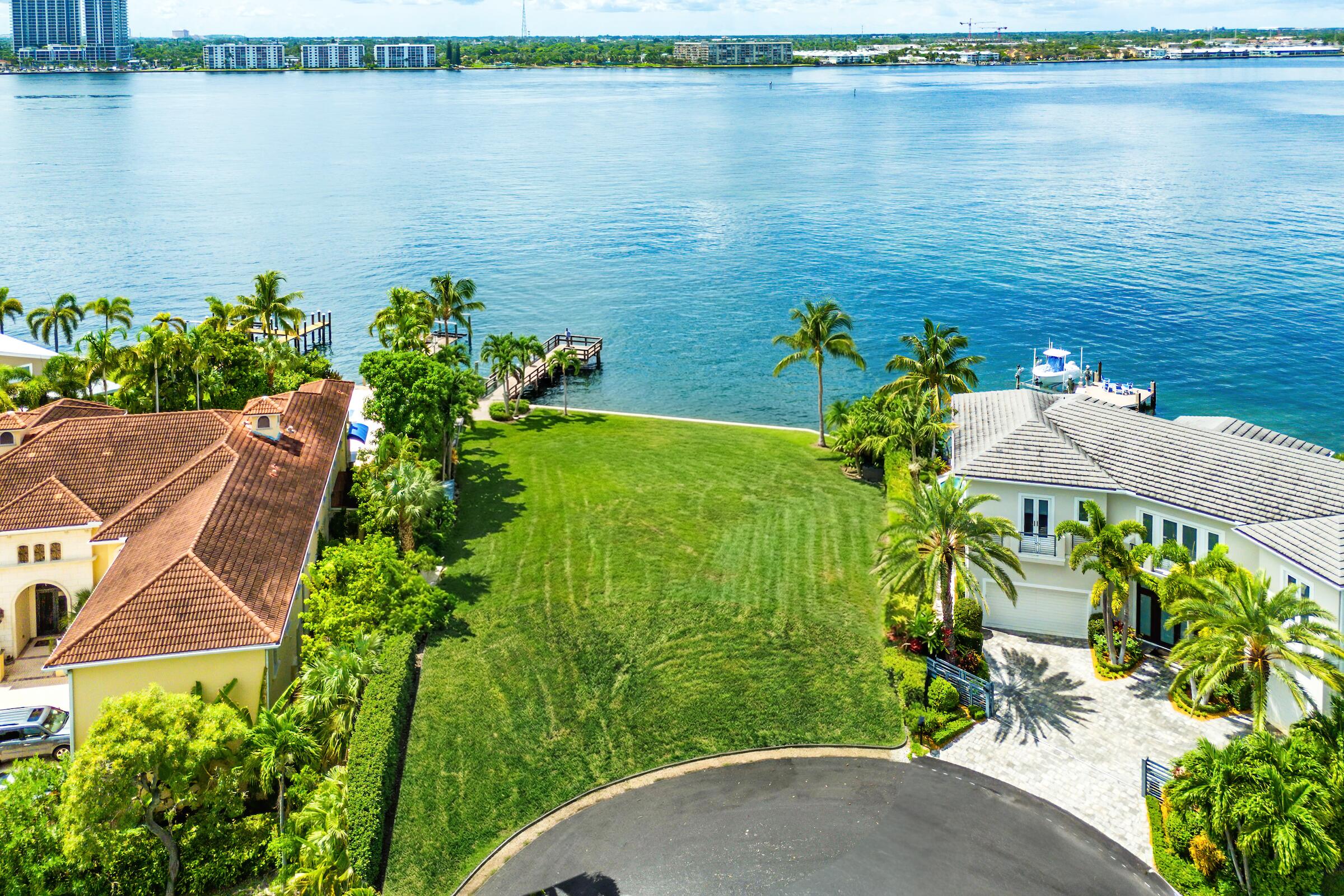 Discover a one-of-a-kind opportunity on Singer Island's most exclusive stretch of single family homes. Positioned on a private cul-de-sac street, 1010 Pine Point Road offers 144 feet of unobstructed Intracoastal frontage with a private dock, 14,000 lb lift, and deep water access just minutes from the inlet, making it a true boater's dream. This Mediterranean Revival residence spans more than 4,000 square feet under air and over 6,000 total, designed for both grand entertaining and quiet waterfront living. A dramatic double-height foyer with a custom cupola floods the home with natural light, leading to expansive living and dining areas finished in marble and natural stone. With four bedrooms, private elevator and a sprawling owner's suite, this home provides scale and gracious livability. Outdoors, a resort-style pool with a large sun deck, sweeping balcony views, and vivid Intracoastal sunsets create an unmatched backdrop for gatherings. The location at the northern tip of Singer Island offers tranquility while still delivering convenience. Walk to the beach and beach clubs, reach PGA Boulevard's fine dining and shopping in minutes, and arrive in Palm Beach or at PBI Airport within twenty minutes.

Whether enjoyed as-is, transformed into a custom coastal retreat, or reimagined as a new luxury build on a rare 14,000 square foot lot, 1010 Pine Point represents the pinnacle of Intracoastal living. With daily visits from manatees, sea turtles, and snook in the backyard waters, it is more than a residence. It is a lifestyle defined by clarity, beauty, and connection to the sea.