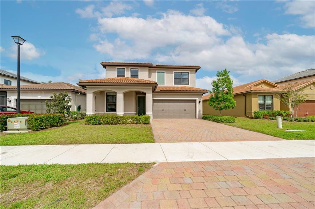 This "Fifth Avenue" model is beautifully designed by DiVosta Homes built in 2018 with over $30k in builder upgrades! This fabulous two-story single-family home with an open floorplan, 4 bed, 2.5 bath, & first floor den. Tasteful Quartz countertops, 48" wood cabinets, large walk-in pantry, lots of cabinetry & natural lighting. Hurricane impact windows & doors. Spacious master bedroom & bath. This desirable new development is close to the turnpike, shopping, dining, and is zoned for ''A'' rated schools. Located in a gated community which boasts two state-of-the-art clubhouses and offers a resort-style pool, basketball courts, tennis courts, fitness center, kids playground, community gathering room with kitchen, fire pit, tot lot! Large lot with ample space to build your own pool. LOW HOA!!