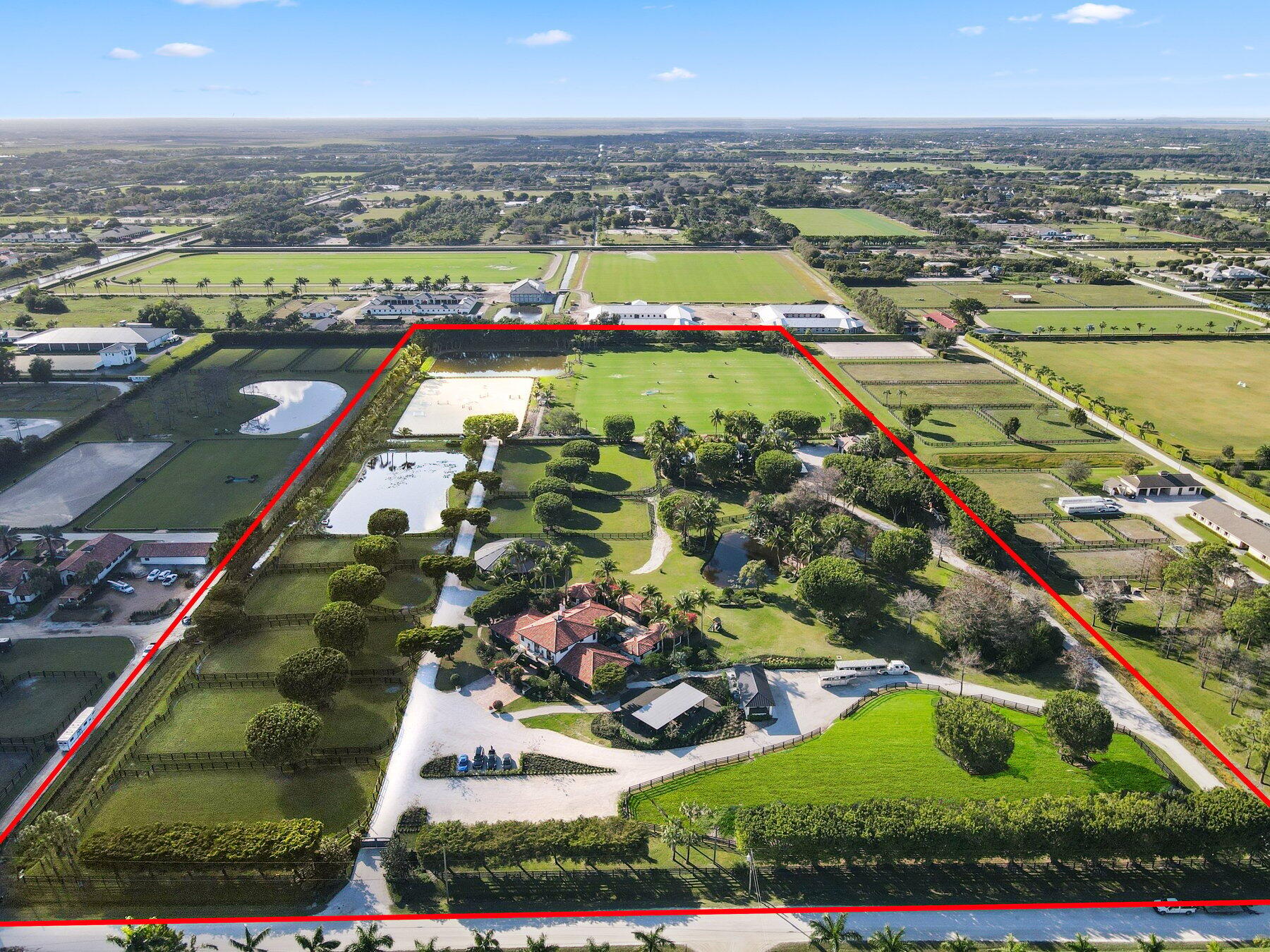 Stunning 21 acre Equestrian Compound located in the heart of Wellington close to all world class horse show and polo venues. Not to be rivaled this estate offers a 14 stall center aisle barn, large tack room, commercial laundry room, luxurious owners quarters with exceptional detail, a tennis pavilion, 6 acre irrigated Bermuda grass jump field and a new 180' X 300' riding arena adjacent to the jump field. There are guest and meeting cottages that open to a grand patio with pergolas over looking the private pond and waterfall. Truly a ''Must See'' property for the serious equestrian.