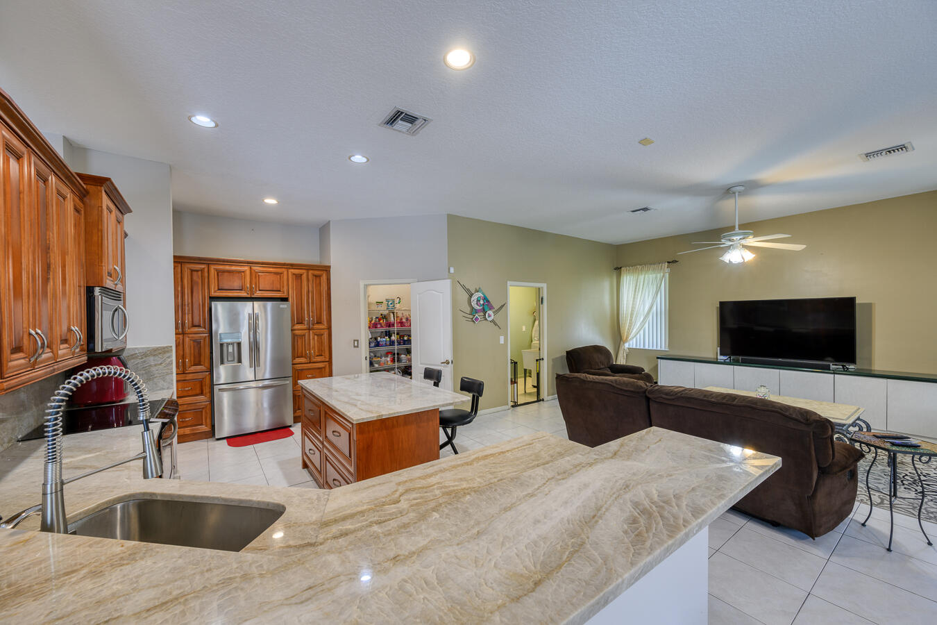 PRICE IMPROVEMENT!  Excellent opportunity! Welcome home to this TRUE 4/4 tucked away in this quiet section of Maplewood Addition is Coral Springs.  Plenty of space for a large family.  Each bedroom has access to their own FULL bathroom.  Kitchen remodeled with Taj Mahal Quartzite  and REAL custom wood  soft close cabinets, stainless steel appliances (2020), and an  Oversized walk in pantry. Hot water heater (2019) Tile roof replaced in 2020.  New garage doors replaced in 2021.  Spare bathrooms have new vanities/sinks.  Screened in pool with ample entertaining space.  Corner lot.  NO HOA!