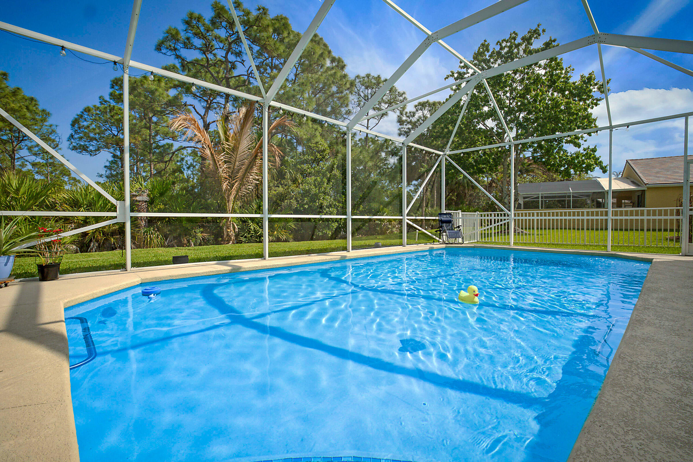 Welcome to this beautifully maintained single-story CBS POOL home nestled on a peaceful preserve lot in the desirable, all ages, gated community of SUMMERFIELD. Offering 3 bedrooms with a potential 4th bedroom, 2 bathrooms, a 2-car garage, and 2,119 square feet of bright, open, living space, this home is perfectly designed for both comfortable everyday living and effortless entertaining.  Thoughtfully updated with major improvements including a new ROOF and GUTTERS (2023), IMPACT WINDOWS, WATER HTR (2022) WOOD LOOK PORCELAIN TILE flooring throughout, and a new POOL DECK AND LANAI SCREENING (2022). This home is truly move-in ready. The low monthly HOA includes basic cable, internet and access to exceptional resort style amenities, including a clubhouse, fitness center, pickleball and tennis courts, and a resort style swimming pool. Perfectly located adjacent to the Champions Club at Summerfield featuring a Tom Fazio designed 18-hole public championship golf course, with pay-as-you-play access. Just minutes to the best beaches, restaurants and shopping!