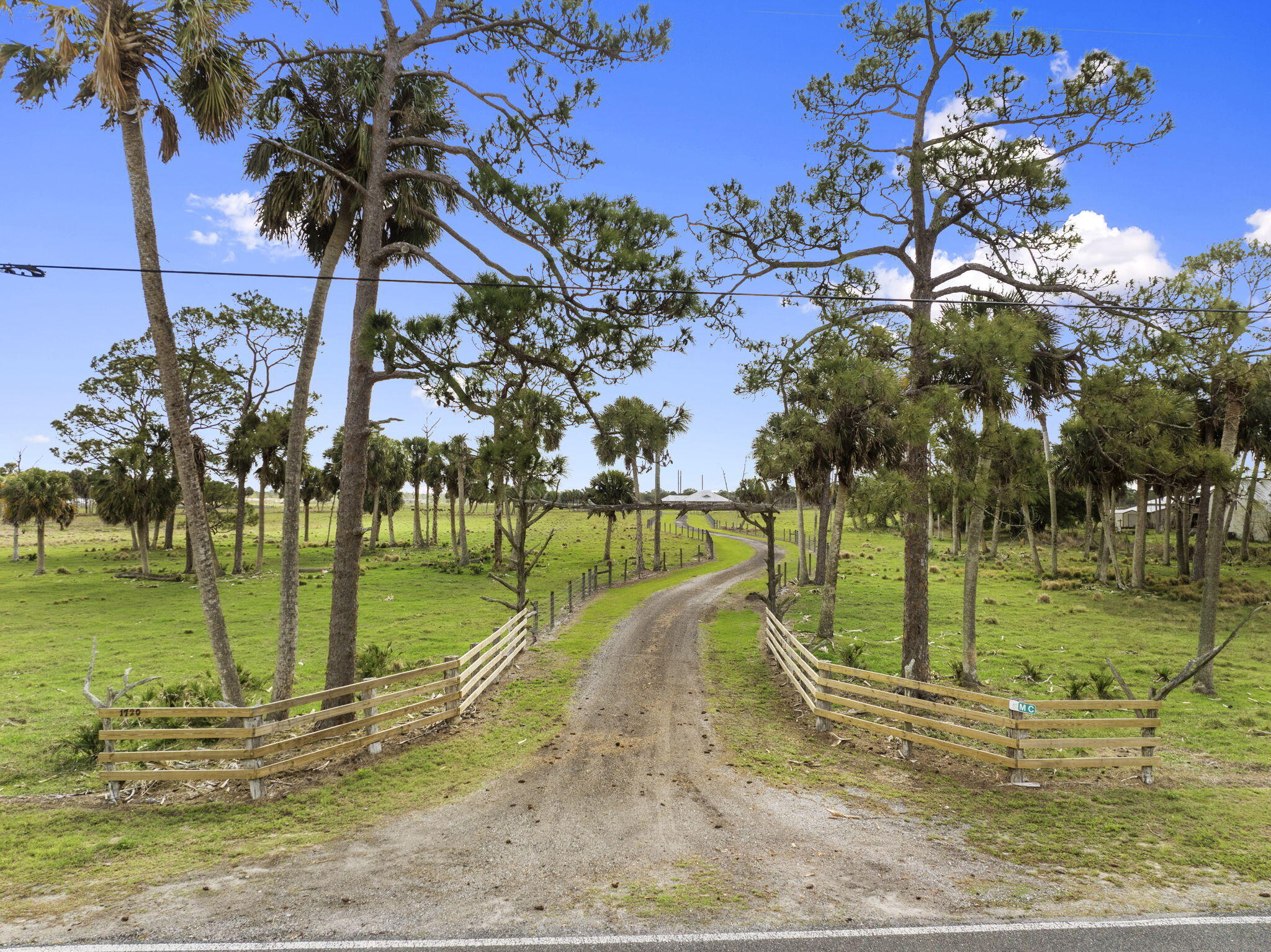 Charming Country Home on 11.11ac with a sizable pond. Large open back porch with bucolic views of cattle pastures, mature trees and the pond. Porch has sink & LP gas stub outs in place for a summer kitchen: design & build your own. Open floorplan concept with 10ft ceilings & 8ft doors provides a feeling of spaciousness, while exposed rustic ceiling beams and a cedar coffered great room ceiling add character.  Kitchen has natural edge, honed finish granite counters with a butcher block island top. Many other thoughtful design details throughout the home. Kitchen range and tank-less water heater are LP gas fed from a buried 500gal LP tank.