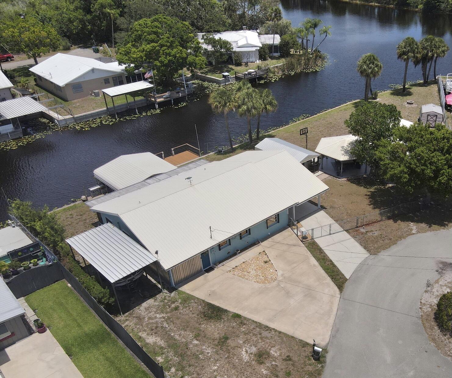 ~RIM CANAL~ HOMES ONLY SECTION- Welcome to your slice of old Florida paradise!! This charming CBS home sits on two spacious lots on a cul-de-sac along a peaceful canal with access to Lake Okeechobee.  This well-maintained spacious home offers an open concept, 2 master suites with walk in closets, metal roof, hurricane shutters, good seawall, Pavilion, 24 X 36 Carolina Shed/ carport, 19 X 16 boathouse, 12 X 12 shed and a 10 X 12 shed. This canal front Gem offers an ideal space for the beautiful Florida sunrise and sunset. All measurements are approximate. Call for your appointment today.
