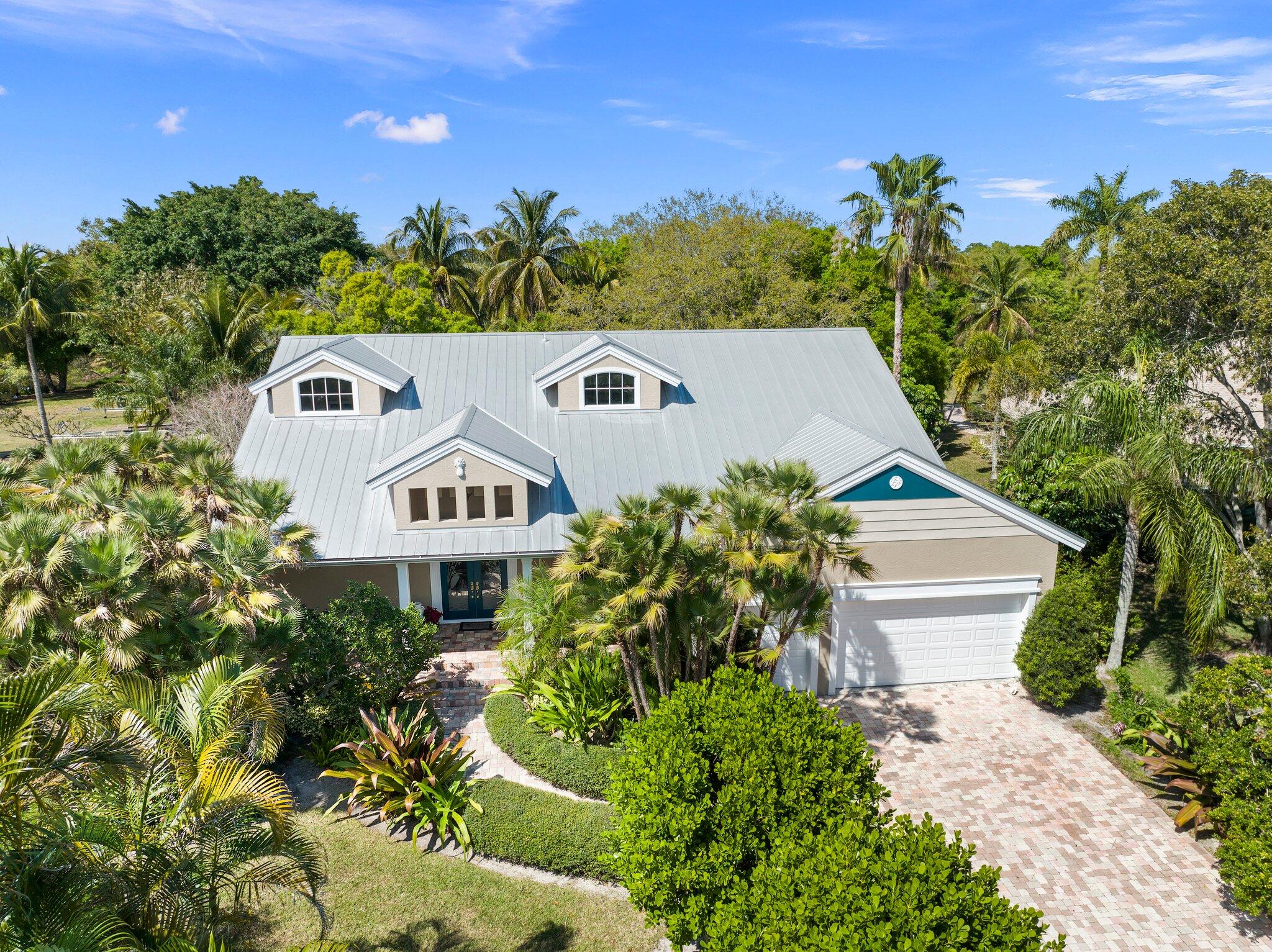 The crown jewel of Sandpiper Bay on .68 acres backing Howard's Creek! This luxury estate with 5 bedrooms plus office/den and 4.5 bathrooms showcases solid construction and elegant design, featuring a gourmet kitchen with center island, breakfast bar, built-in desk, formal dining room, spacious living area, second bedroom, home office, and cabana bath on the main level. Upstairs offers three bedrooms, 2.5 baths, media room with wet bar, family room, and loft--ideal for guests and flexible living. French doors open to a spectacular 44x22 pool and spa, expansive patio, and lush landscaping. Impact windows throughout. Built to exceed code with 10-ft concrete block walls, steel floor joists, steel trusses, and 16-inch on-center construction for exceptional strength and durability.