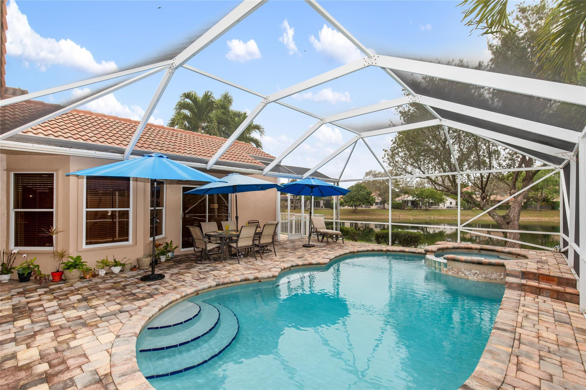 IMMACULATELY MAINTAINED, UPDATED & PRICED TO SELL - PARKLAND'S BEST 4 BEDROOM POOL HOME VALUES! Located within the intimate guard-gated community of Whittier Oaks, this immaculately maintained, move-in ready home features a screened patio / pool overlooking peaceful lake views. Creating the perfect private retreat rarely found at this price point. Inside, the vaulted ceilings enhance the spacious living areas & primary suite. The updated kitchen is appointed with wood shaker cabinetry, quartz countertops, & stainless steel appliances, while both bathrooms have been tastefully updated. Major updates include a 2016 roof & a 2025 A/C. Ideally situated next to Terramar Park with tennis, pickleball, basketball, soccer, baseball, playgrounds, and more. HOA includes lawn care and guard gate!