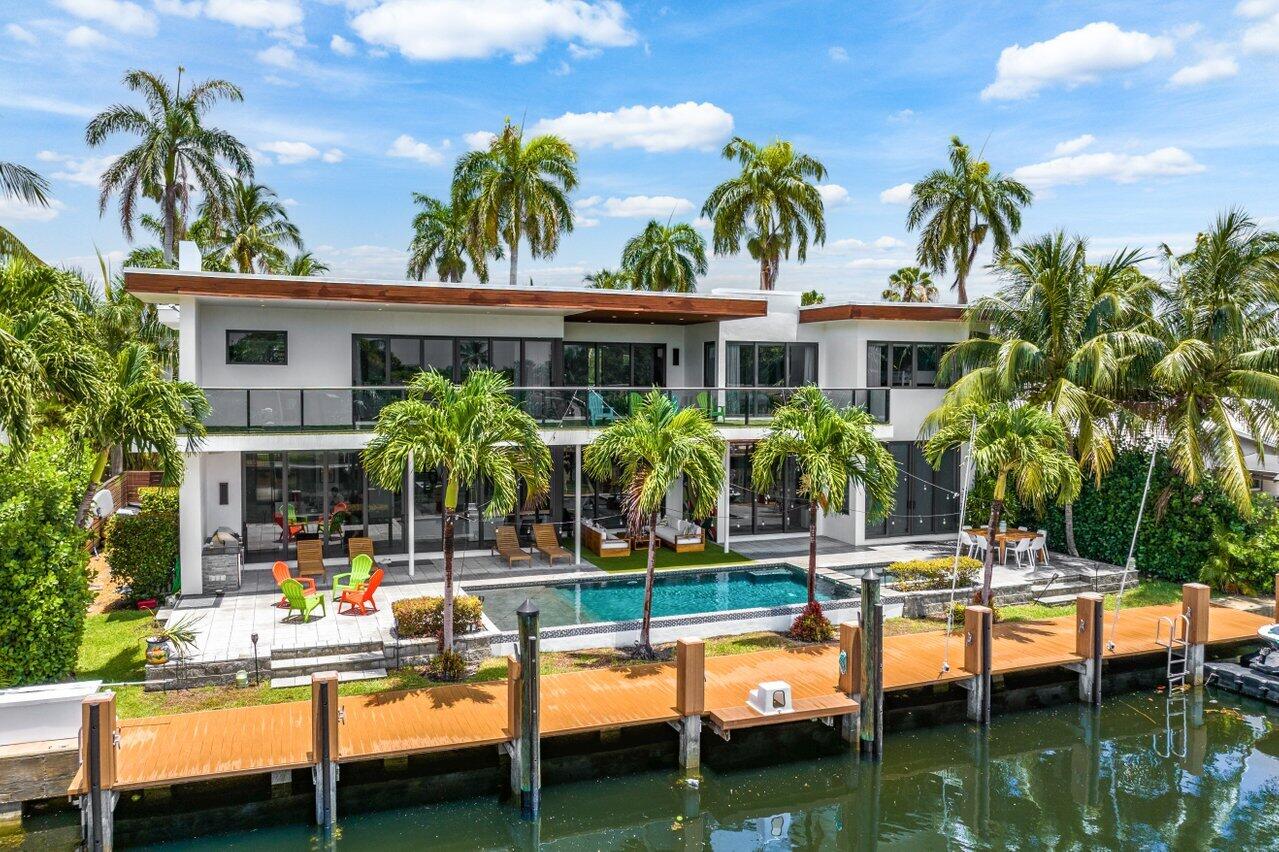 Luxurious 2016 custom estate home with 5 bedrooms plus loft & office, 6.5 bathrooms, a 3 car garage, saltwater pool, and 5250 living square feet on a 10,000 square foot lot w/ 100 feet of waterfrontage w/ private dock in fabulous Coral Ridge.  This beautiful home will wow even the fussiest of buyers with everything from its great curb appeal to its modern yet functional floor plan. Features include a double height glass entrance, volume ceilings, gourmet kitchen w/ Italian cabinetry, Sub-Zero refrigerator and Wolf range. a sparking saltwater pool & spa,
gas heater, summer kitchen, upper floor balcony w/ turf for easy maintenance, Grotto & Toto plumbing, 3 a/c units with UV systems, custom closet organizers, a wine cellar, a maids' quarters w/ bathroom, gym, 3 car garage, and so much more.