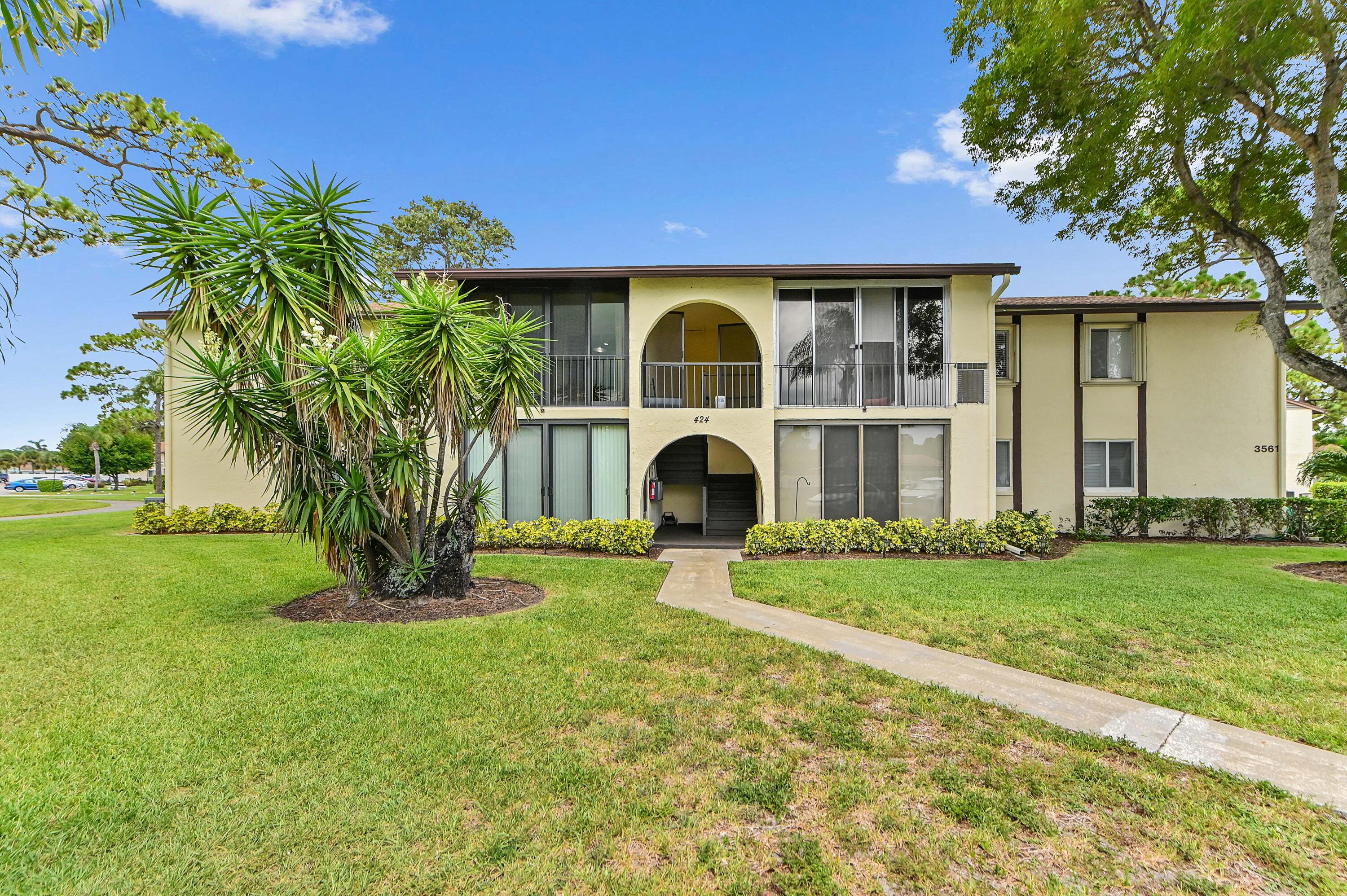 Welcome to this charming 2-bedroom, 1.5-bathroom lakefront condo in the desirable Pine Ridge North Village IV, an active 55+ community in Greenacres. Offering 935 square feet of comfortable living space, this condo features beautiful wood flooring throughout and a bright, functional layout designed for easy living. The renovated kitchen is equipped with ample cabinet storage, a countertop with bar seating, and a convenient washer and dryer. Enjoy added peace of mind with plantation shutters on all windows and accordion shutters on the balcony. Step outside to your private balcony and unwind while taking in the tranquil lake views.   Residents of Pine Ridge North Village IV enjoy an array of resort-style amenities, including a heated swimming pool, shuffleboard, bocce courts, and two scenic lakes, one featuring a paved walking trail. The community also offers multiple charcoal grilling areas with picnic tables and benches, creating the perfect setting to relax, socialize, and enjoy the Florida lifestyle.