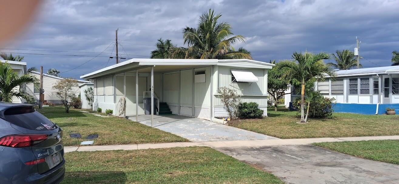 Sought after complex in Palm Beach County, deeded lot you OWN the land, no expensive lot fees, 2 BR, 1.5 baths, low HOA fees includes lawn cutting, refinished heated pool, clubhouse with many activities, shuffleboard, petanque, bocce, golf cage, bring your finishing touches, carpets removed in kitchen, living room, enclosed patio entry, & 1 bath. laminate floor in BR's, Priced accordingly below market, bedrooms will look great with new paneling, 1 time land share $750 refundable at resale, golf carts & motorcycles allowed, 30 lb pet limit, age 55+ adult community, perfect investment for snowbird or full time resident, attached carport,  large shed with washer/dryer, come see it for showing now! 5 miles to beach, close to I95, Tpke, WPB airport, fine dining, shopping. Great opportunity! Sub flooring in good condition, Range, W/D included. pet restrictions 1 dog <30 lbs or 2 cats. allow 30 days HOA approval. No commercial vehicles. Sidewalks with new safety tread corners.