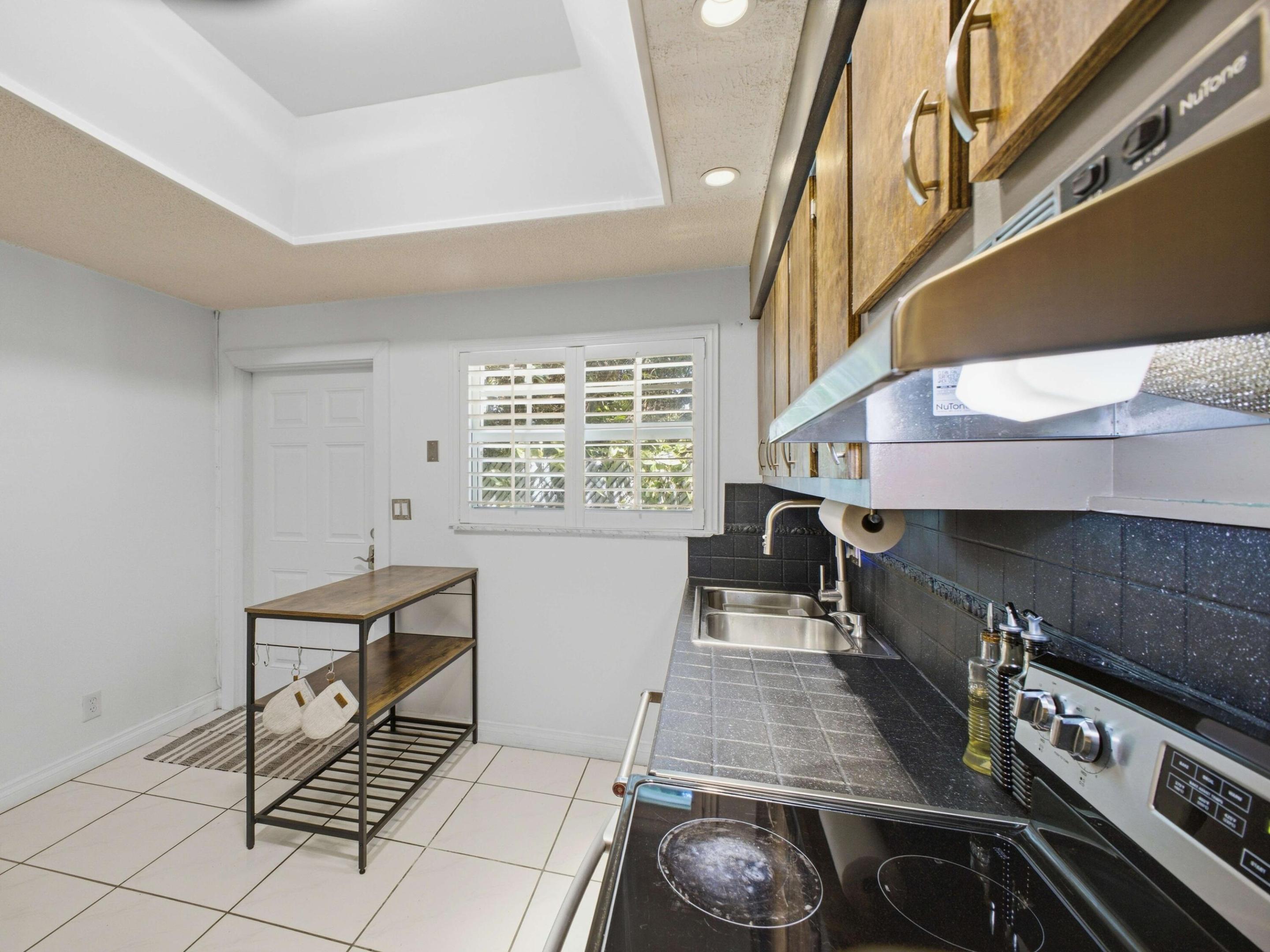 VA-approved Hollywood condo with potential zero-down financing. Spacious corner townhouse-style unit has 2 primary suites, each with private bathrooms, updated showers & walk-in closets. The first floor has tile flooring, plantation shutters, natural light, a half bath & views of the tropical courtyard & pool. Major updates include impact windows & storm doors (2025), A/C (2019) , water heater, in-unit washer/dryer, and NEW ROOF (2025). The kitchen features wood cabinetry, stainless steel appliances & rear access to a shaded BBQ/patio area. HOA includes common areas, insurance, roof repairs, water, sewer, pool service & exterior maintenance. Walk to downtown restaurants, shopping, parks, playgrounds, and beaches. Easy showings anytime!