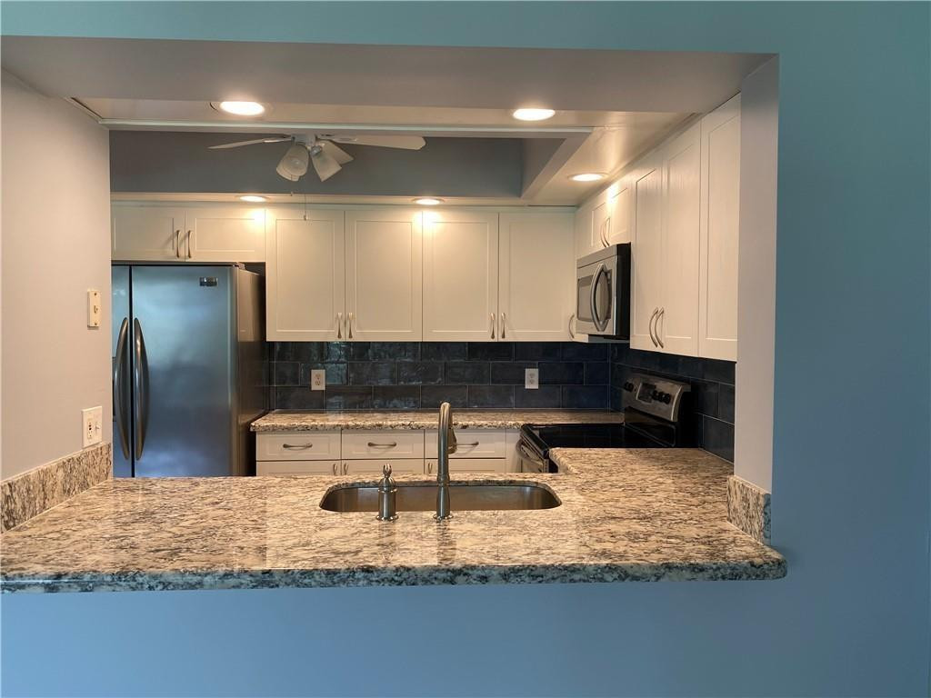 Spacious and desirable 1-bedroom, 1.5-bath condo on the third floor with beautiful golf and water views. This bright unit features neutral colors, tile flooring throughout, stainless steel appliances, and an in-unit washer and dryer. Enjoy the screened balcony, assigned parking, guest parking, and elevator access. Conveniently located near highways, shopping, restaurants, parks, the library, hospital, and professional offices. Located in an active 55+ guard-gated community offering first-class amenities, including a clubhouse, fitness center, theater, pools, tennis courts, courtesy transportation, security patrol, golf access, and more.