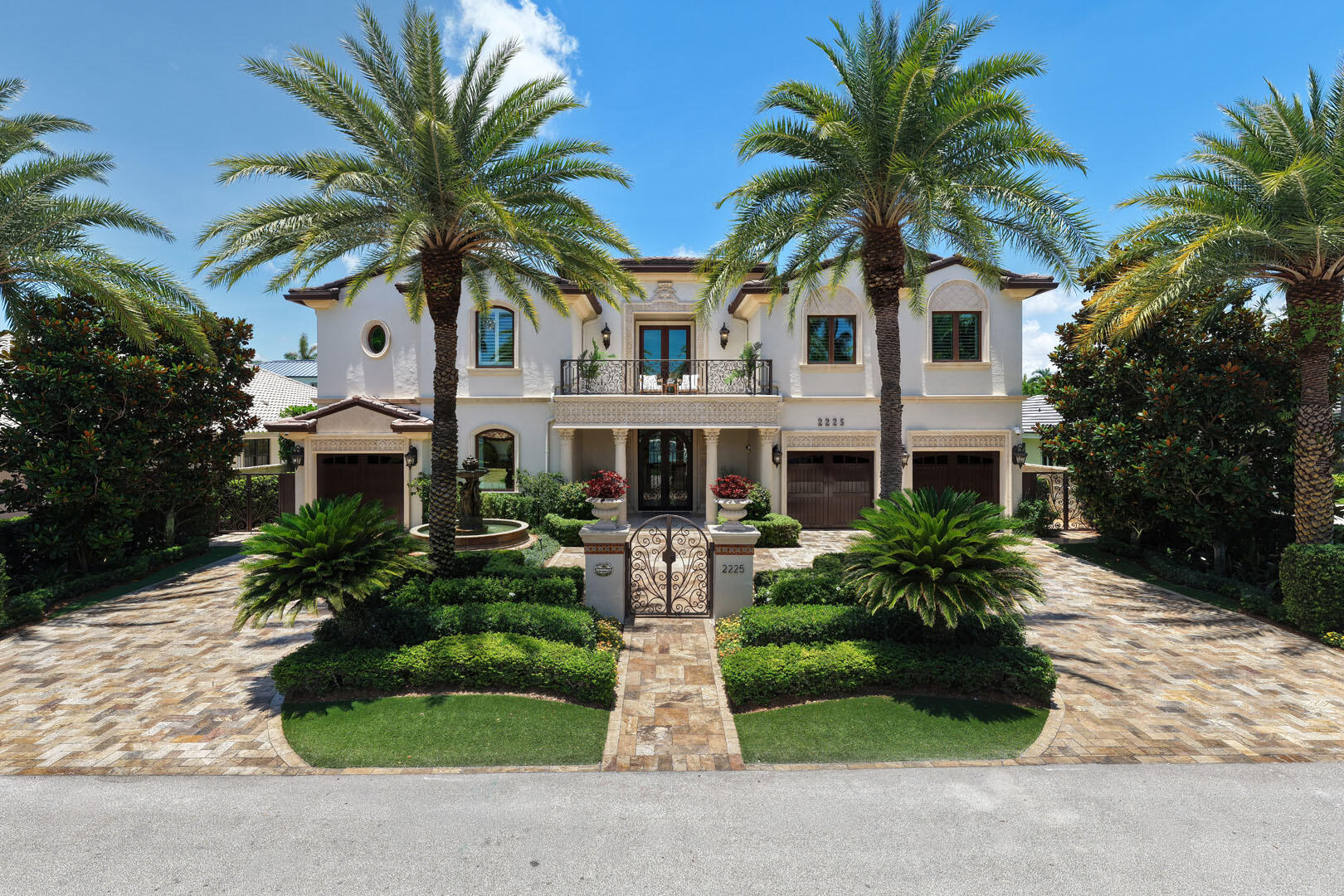 Positioned within the prestigious gates of Royal Palm Yacht & Country Club, this Mediterranean-inspired custom estate presents over 6,800 square feet of meticulously crafted living space, designed for both grand-scale entertaining and effortless everyday living.   A circular driveway framed by pristine landscaping creates an impressive arrival, leading to a residence distinguished by timeless architecture, custom millwork, rich marble flooring, and exceptional attention to detail throughout. Elegant formal living and dining spaces are complemented by designer lighting and a well-appointed butler's pantry, while the gourmet kitchen serves as the heart of the home, featuring an oversized center island, premium appliances, and a generous walk-in pantry.   Designed to accommodate every aspect of modern luxury living, the residence offers a private office, loft-style living room, dedicated exercise room, and a custom eight-seat theater complete with a full beverage center. An elevator and natural gas service further enhance convenience and functionality.   The master suite occupies a private retreat of its own, highlighted by a secluded balcony overlooking the grounds, dual spa-inspired bathrooms, and expansive custom walk-in closets.   Beyond the interiors, a resort-inspired outdoor setting unfolds with a heated pool and spa, outdoor fireplace, covered loggia, summer kitchen, and multiple alfresco dining areas—creating a seamless extension of the home's entertaining spaces. Protected by impact glass and doors and serviced by three garage bays, this exceptional offering combines enduring Mediterranean elegance with the finest amenities in Boca Raton's most sought-after country club community.
