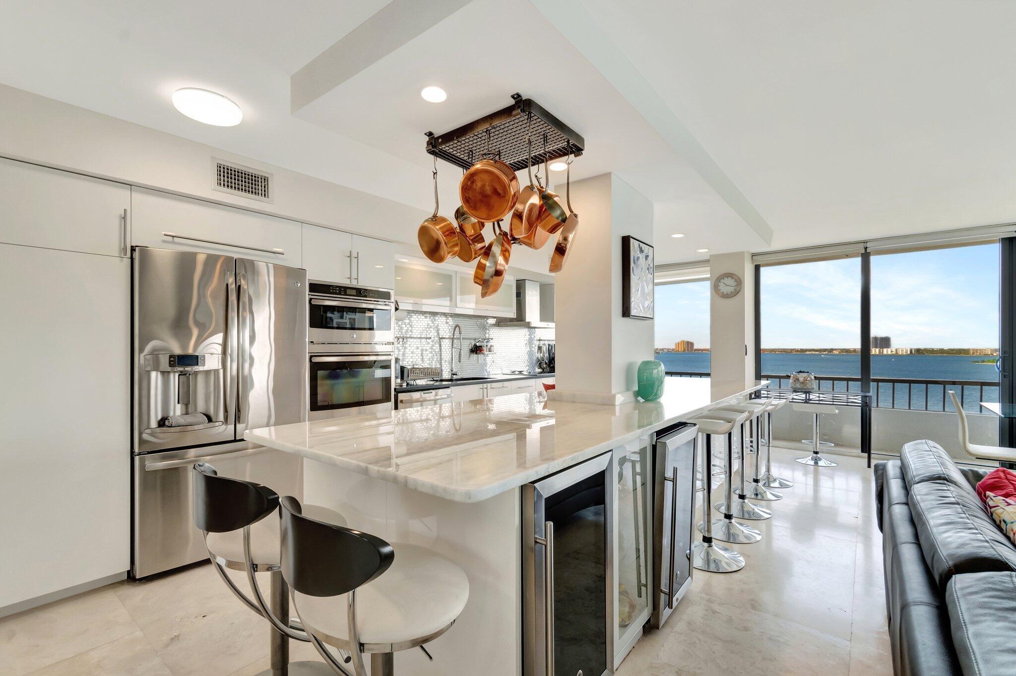 57 FOOT WRAP AROUND BALCONY WITH UNOBSTRUCTED VIEWS OF THE BLUE ATLANTIC OCEAN,INTRA COASTAL WATERWAYS AND JOHN MACARTHUR BEACH STATE PARK. ALL TILE FLOORS IN THE ENTIRE UNIT HAS BEEN TOTALLY UPGRADED OPEN KITCHEN, WASHER AND DRYER IN UNIT, 2 NEW BATHROOMS,WALL TO WALL AND FLOOR TO CEILING IMPACT WINDOWS THROUGH OUT THE UNIT. WASHER AND DRYER IN UNIT, 2 WINE COOLERS, 2 HEATED POOLS,NEW CLUBHOUSE ,PUTTING GREEN,4 TENNIS COURTS, SHUFFLE BOARD, BBQ PAVILION,24 HOUR SECURITY GATE, AND MOST IMPORTANT 1200 FEET OF SANDY BEACH AT YOUR FOOTSTEPS.