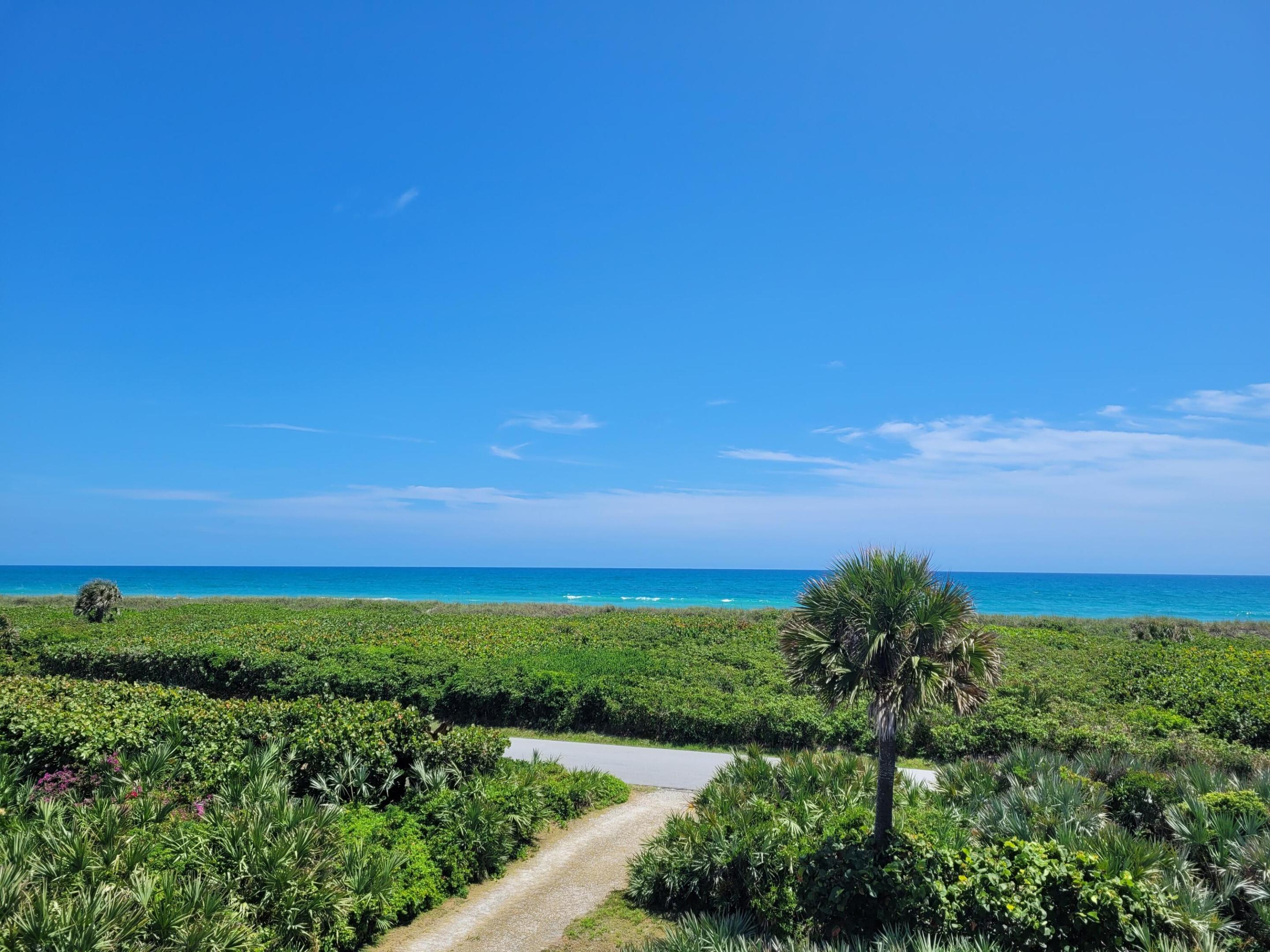 Incredible unobstructed wide ocean views from this elevated three bedroom, two and one half bath poured concrete home on Jupiter Island. Preserved conservation property to the east for unobstructed views and beach access just steps away.  New standing seam metal roof and 5kw solar electricity generating system. Very private location with conservation land to the east and west and a non buildable lot to the south.