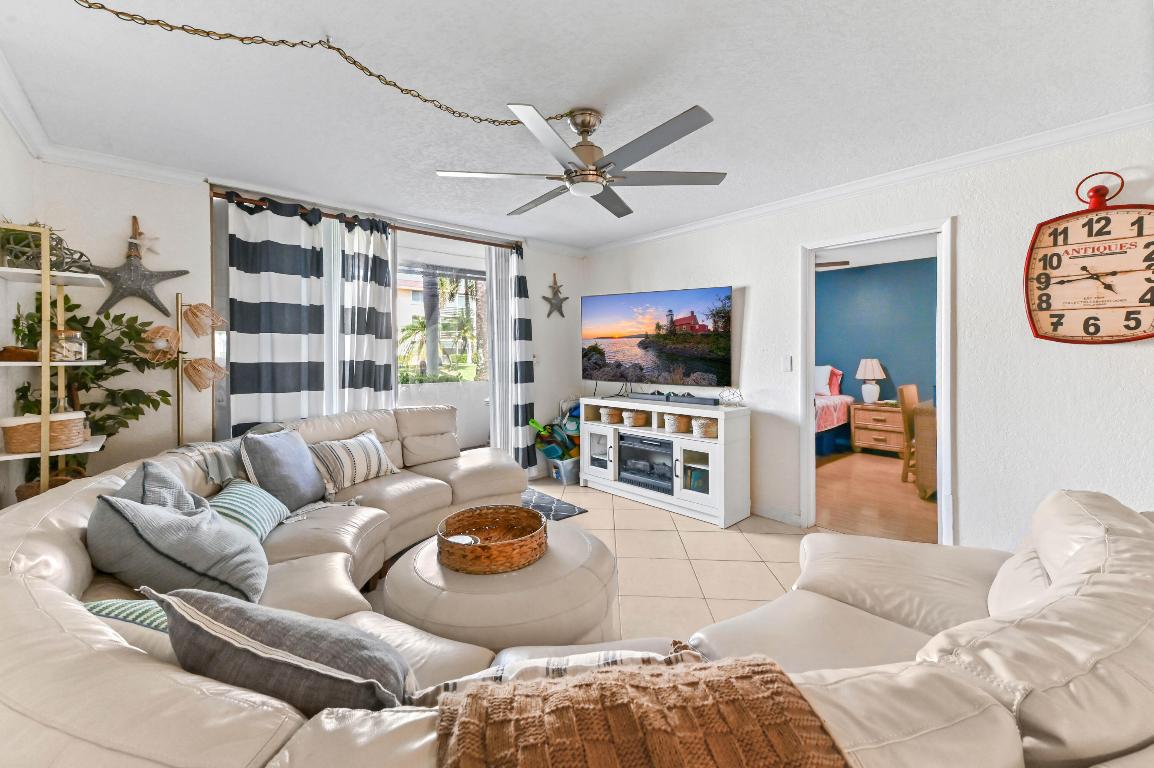 Welcome to Lighthouse Point Plaza Condo, a charming 1st-floor unit of a 3-story community offering comfort and convenience in the heart of Lighthouse Point. This condo features open living space, comprising 2 bedrooms each with a walk-in closet and 2 bathrooms. The entry foyer with a closet leads to a kitchen with cabinet storage, refrigerator, microwave, and range/oven, flowing into the dining and living areas.  The home features tile flooring in the main areas and laminated flooring in the bedrooms. From the living room, sliding doors with accordion shutters open to a screened and covered patio only a few steps away from the pool. Additional highlights include accordion shutters throughout for storm protection. Community amenities include a pool, shuffleboard, and more, along with a common dock and available dock options, offering residents the opportunity to enjoy South Florida's boating lifestyle.  This residence combines comfort, convenience, and a desirable poolside setting, making it a wonderful place to call home.