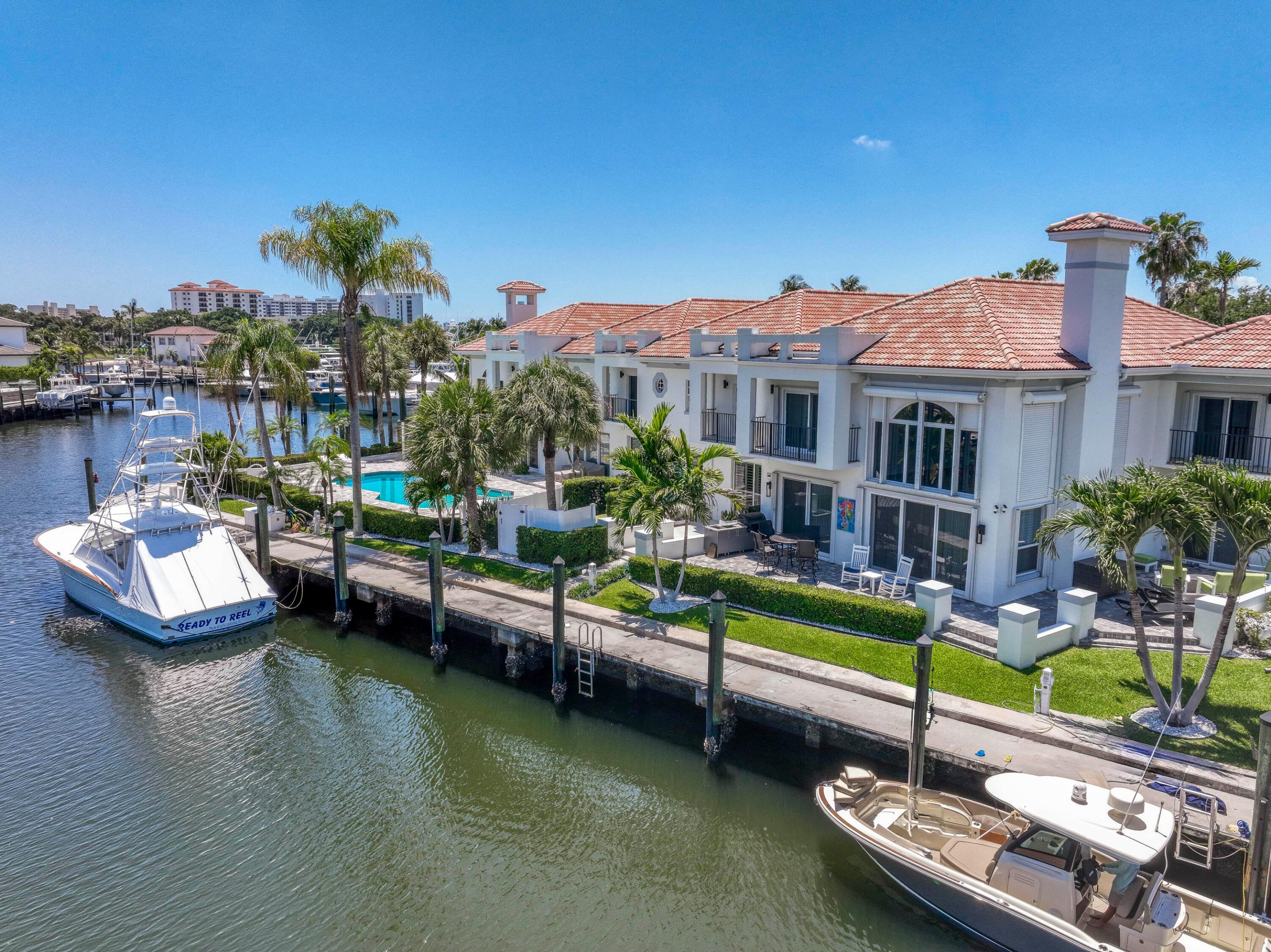 Spacious 3-bedroom, 3.5-bath waterfront townhome with a 57' x 25' deeded dock, ideally situated on the protected three-sided island community of Harbour Point. This beautifully maintained residence features impact windows and plantation shutters throughout, an open-concept kitchen with a large center island, elegant Taj Mahal quartzite countertops, stainless steel appliances, and timeless travertine flooring. The freshly painted interior showcases classic wood flooring throughout the second level, leading to generously sized guest suites with updated en-suite bathrooms. The primary suite offers an oversized custom walk-in closet and a private balcony for added comfort and relaxation. Step outside to your peaceful waterfront patio, recently retiled and perfect for enjoying the passing boats, with the convenience of your boat docked just steps away. A true boater's paradise with no fixed bridges to the ocean and easy access to both the Palm Beach and Jupiter Inlets. Additional upgrades include a new roof and gutters (2021), both HVAC systems replaced in 2023, and a new impact-rated garage door installed in 2023. The charming seven-residence Harbour Point community recently completed a comprehensive exterior beautification project featuring upgraded lighting, refreshed building finishes and exterior paint, new paver driveways and walkways, enhanced landscaping, a new security gate and electronic entry system, and an expanded community pool with a stunning Silver Travertine marble deck. Exceptional location close to premier shopping, dining, beautiful beaches, and just 20 minutes from Palm Beach International Airport.