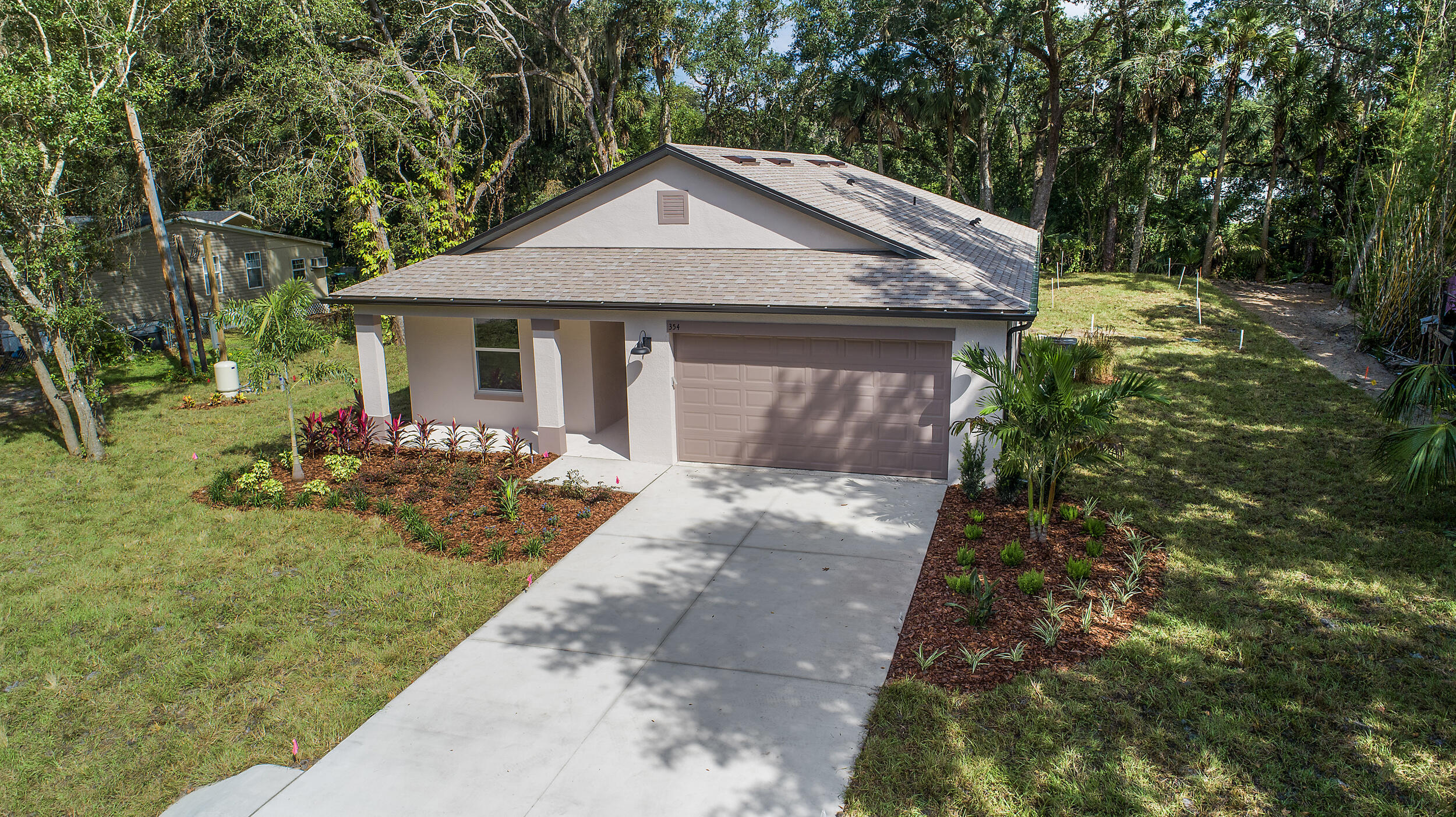 Move-in ready and beautifully designed, this brand-new Eastern Homes construction offers 3 bedrooms, 2 baths, and 1,771 sq. ft. of modern living on a spacious .36-acre homesite in Sanford. The open-concept floor plan features 9'4" ceilings, a gourmet kitchen with quartz countertops, a large island, 42" cabinets, and a walk-in pantry, plus a covered lanai perfect for indoor-outdoor living. The private primary suite includes a walk-in closet and dual vanities, while the split-bedroom layout provides added privacy. Additional highlights include a mudroom, dedicated laundry room, quality finishes throughout, and a large backyard with room for a pool or outdoor entertaining. Conveniently located near shopping, dining, and major highways, this home offers the perfect combination of style, space,