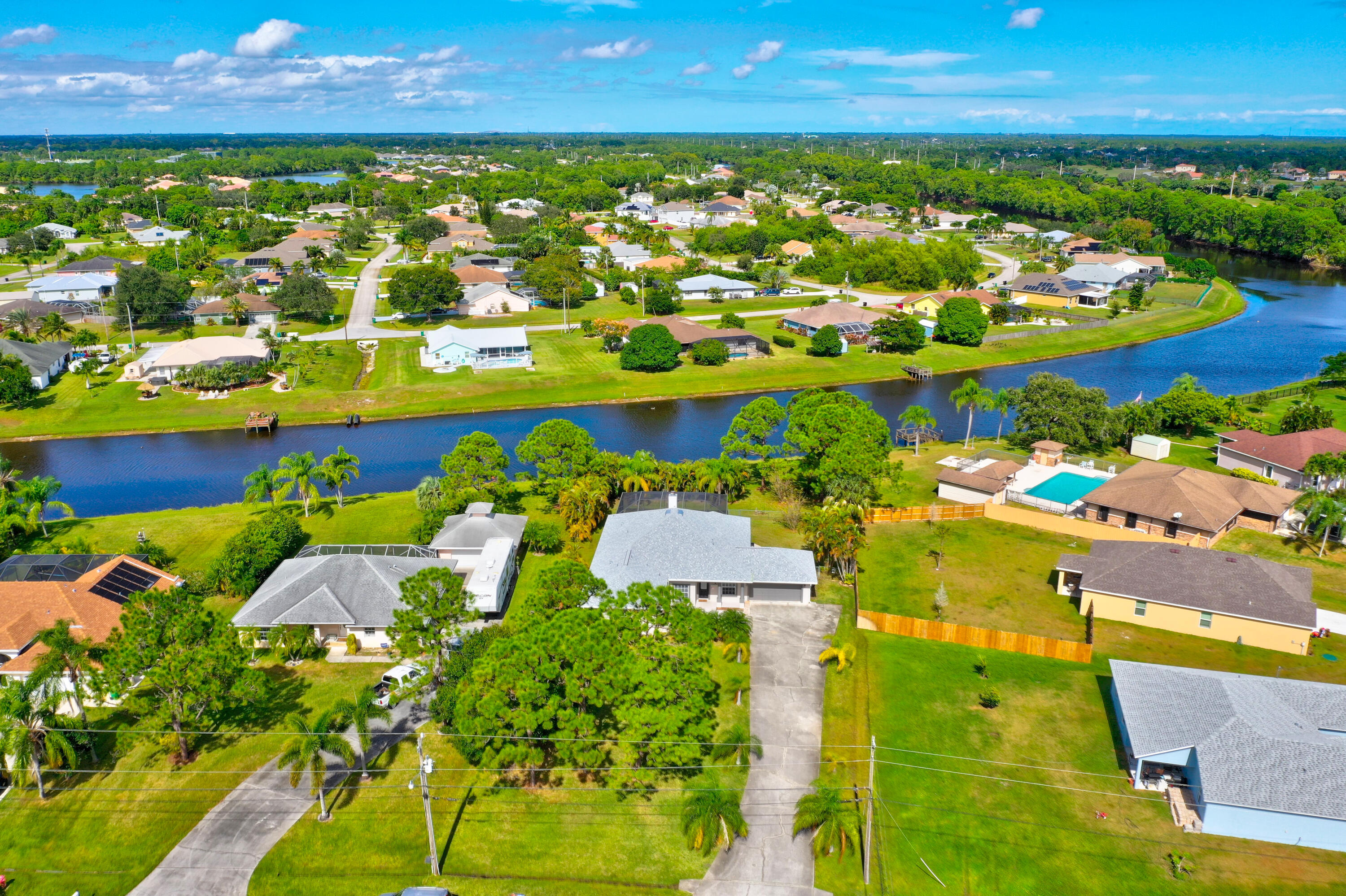 INCOME PRODUCING HOME, WATER FRONT LIVING, and Florida lifestyle all in one beautiful property. This well-maintained CBS POOL HOME SITS ON OVER HALF ACRE WITH NO HOA and offers 4 bedrooms, 3.5 baths, volume ceilings, tile floors, and a spacious open kitchen. The private mother-in-law suite features a kitchenette, full bath, and separate entrance. Enjoy a HEATED SCREENED IN POOL with peaceful water views, perfect for kayaking, canoeing, fishing, or relaxing at sunset. Highlights include a 2023 ROOF, 2021 A/C, updated baths, new washer/dryer, new pool heater, new refrigerator, generator with dedicated panel, fireplace, and 104-foot driveway for cars, boat, or RV. EXCELLENT INVESTMENT OPPORTUNITY OR A GREAT PLACE TO CALL HOME!