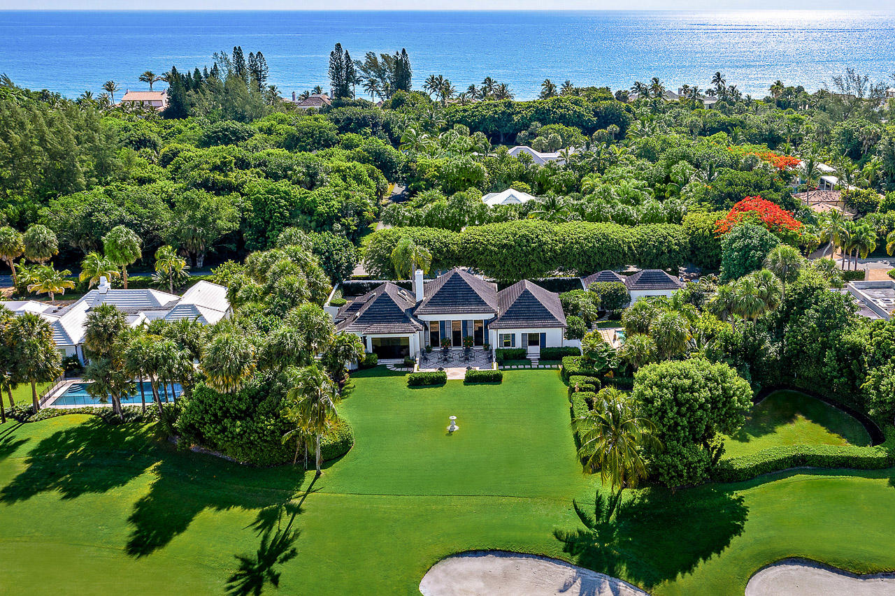 Designed by distinguished architect F Burrall Hoffman, 26 Gomez Road is one of Jupiter Island's most iconic and beloved houses. Sitting on over a half acre with glorious views of the golf course and creek beyond, this wonderful property is anchored by old growth trees, lush landscaping and formal gardens. The living room includes a soaring ceiling, Louis XV fireplace surround and wet bar. In the master bedroom, antique French boiserie paneled walls add to the elegance found throughout the house. Large cook's kitchen with separate breakfast area and expansive pantry includes top of the line appliances. There is a separate two bedroom guest house adjacent to the pool which allows guests and family privacy.  Convenient location minutes from the bridge allows quick off Island access.