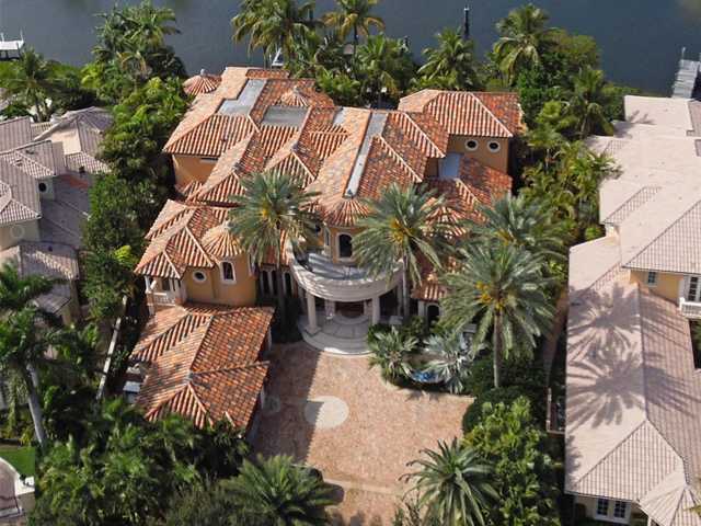 Discover opulence on 130 ft. of waterfront! Over 9,000 sq. ft. with flowing lines accented with exotic woods, walls of glass, Venetian plaster, intricate stone work, limestone floors, signature lighting, and power ceilings. ALL State-of-the-art! Lavishly appointed interiors are complimented by graciously proportioned rooms and fine architectural detailing. High tech security and state-of-the-art electronics take luxury to a new level of convenience. The two story foyer features an extraordinary floating stone and glass staircase. The massive 37x31 foot, two story living room has a hidden Media wall, a circular wet bar and tranquil views of the gorgeous lanai, rock waterfall and lushly lanscaped pool. The dramatic circular dining Room has a rounded wall... (see supplement for full remarks) Discover opulence on 130 ft. of waterfront! Over 9,000 sq. ft. with flowing lines accented with exotic woods, walls of glass, Venetian plaster, intricate stone work, limestone floors, signature lighting, and power ceilings. ALL State-of-the-art!Lavishly appointed interiors are complimented by graciously proportioned rooms and fine architectural detailing. High tech security and state-of-the-art electronics take luxury to a new level of convenience. The two story foyer features an extraordinary floating stone and glass staircase. The massive 37x31 foot, two story living room has a hidden Media wall, a circular wet bar and tranquil views of the gorgeous lanai, rock waterfall and lushly lanscaped pool. The dramatic circular dining Room has a rounded wall of glass, a rotating illuminated round table, and magnificent lighting. The Kitchen and breakfast area are a blend of contemporary panache and state of the art practicality for the home chef. Other exquisite rooms include, a library, a casual chic family room, a temperature controlled wine cellar and staff quarters. Occupying the entire right wing of the estate is the sumptuous master suite, complete with large walk in closets and an office overlooking the resort style pool. The opulent Master Bath is hallmarked by a luxurious roman tub and glass shower overlooking a tropical privacy garden. The second floor of this palatial estate is completed by three superb suites with water views, and a stunning theater room. Designed with entertaining in mind this showplace is equipped for any occasion. The dock can accomodate an 80 ft. yacht & is just moments from the Intracoastal. Truly a work of Art, and a Florida Oasis with the warmth of a love filled home...a must see!