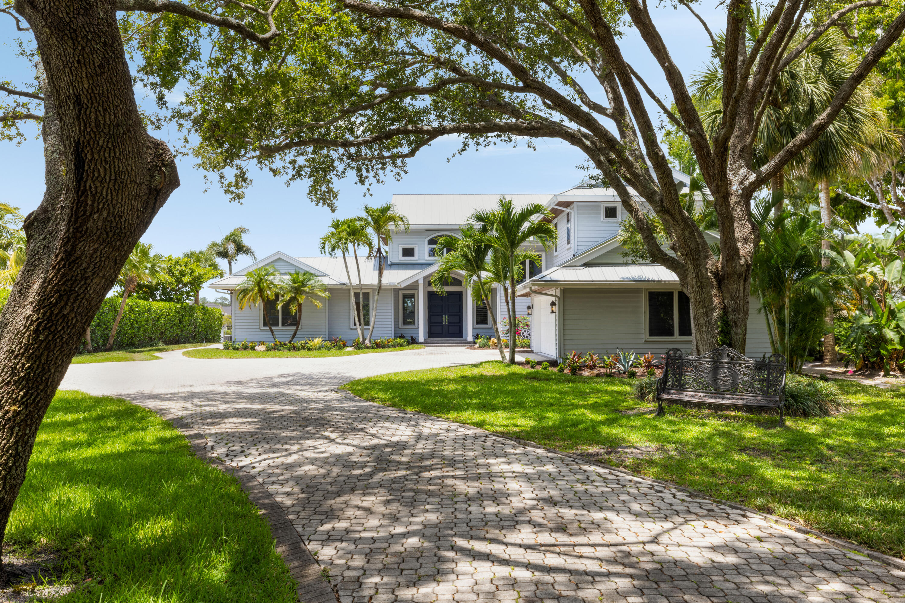 Private Riverfront Estate with Resort-Style Pool, Dock & Nearly an Acre of Land

Tucked away behind a gated entry on the scenic Loxahatchee River, this extraordinary waterfront property offers the rare combination of privacy, space, and luxury. Set on nearly an acre in a prime Jupiter location, the home spans 4,400 sq ft with 4 bedrooms, 3.5 bathrooms, a versatile bonus room, and an open loft area perfect for a home office, playroom, or additional lounge space.

River views abound from the porches, decks, and numerous large windows, flooding the interiors with natural light. The home features rich hardwood floors throughout and marble finishes in the primary bathroom, paired with plantation shutters that add timeless style and privacy. Upstairs includes its own private balcony, offering elevated views of the river and surrounding landscape.

Inside, the chef's kitchen is equipped with Sub-Zero and Wolf appliances, a spacious quartz island, a built-in coffee machine, and opens seamlessly to the main living and dining areas. Just off the main space, a separate wet bar overlooks the river, creating the perfect setting for entertaining with a view.

Step outside to your private tropical oasis, complete with a brand new pool and spa along the water's edge. A redone dock is equipped with both a 30,000 lb boat lift and a 12,000 lb lift, making this home a true boater's dream with direct access to the Loxahatchee River and beyond.

Additional highlights include two new air conditioning units, partial impact windows, and a flexible floor plan tailored for modern living.

This move-in-ready riverfront retreat is an exceptional opportunity to enjoy the very best of Florida living in one of Jupiter's most sought-after waterfront settings.