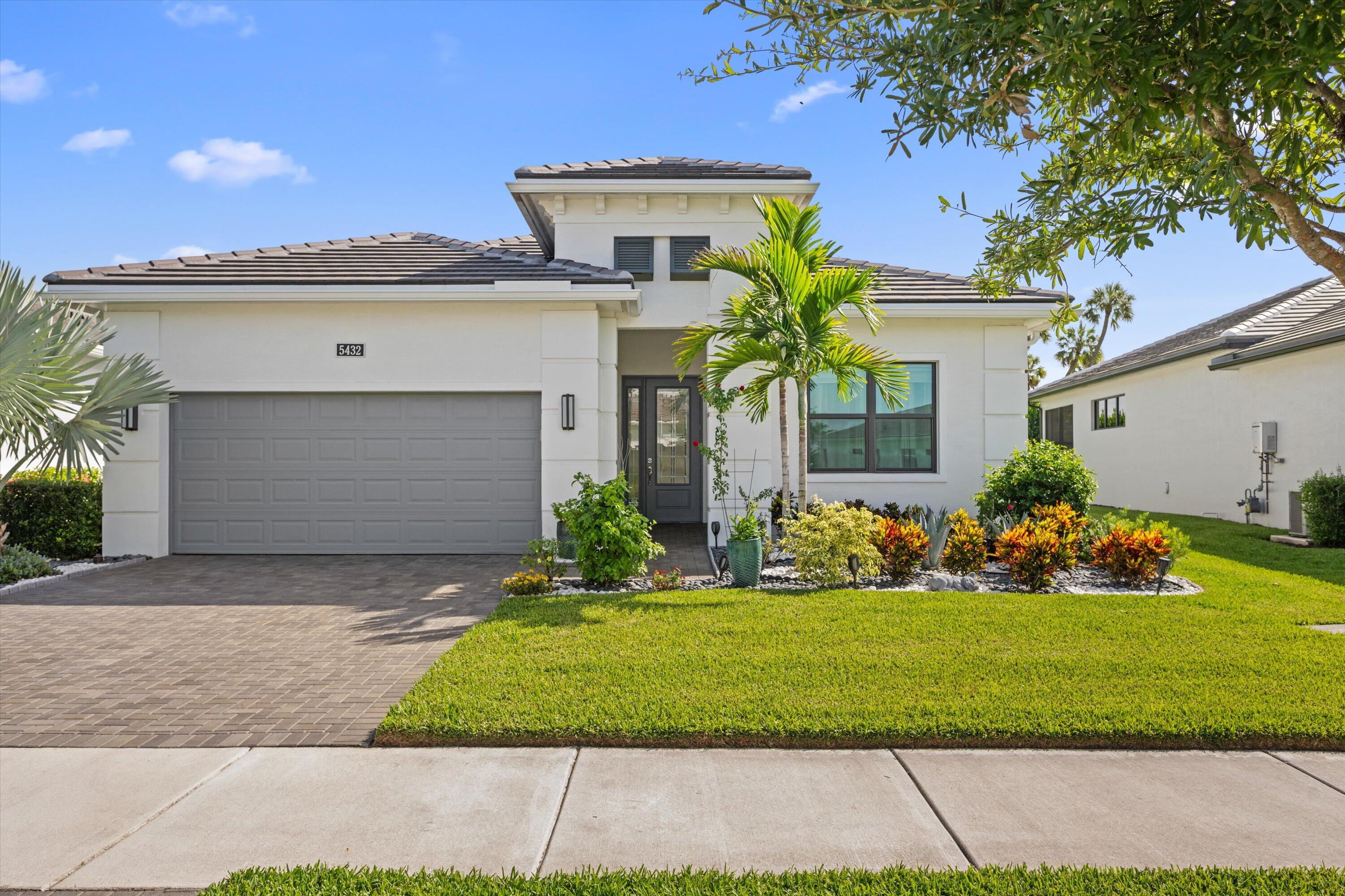 Extensively upgraded inside and out, this exceptional Cresswind Palm Beach residence offers luxury finishes, exceptional privacy, and the resort-style lifestyle that makes 55+ living in Westlake so desirable. Situated on one of the community's most beautifully landscaped homesites, this fenced property backs to an elevated berm with no rear neighbors, creating an extraordinary sense of privacy. The extended screened lanai with a fully equipped summer kitchen makes outdoor entertaining effortless. Inside, you'll find soaring tray ceilings, porcelain tile flooring, custom wall accents, designer lighting, and an open-concept layout centered around a stunning gourmet kitchen featuring an oversized quartz island, premium cabinetry, built-in appliances, designer backsplash, a natural gas cooktop and high-end finishes. Designed for both comfort and peace of mind, the home also features impact-resistant windows and doors, a whole-house water filtration system, natural gas service, a tankless gas water heater, and a natural gas dryer. The luxurious owner's suite includes a spa-inspired bath and custom walk-in closet, while the versatile flex room easily serves as a home office, media room, fitness space, or hobby room. Located in Cresswind Palm Beach, Westlake's premier 55+ active adult community, residents enjoy resort-style amenities including a private clubhouse, fitness center, resort pool and spa, pickleball, tennis, bocce, scenic walking trails, dog parks, arts and crafts studios, and an active social calendar. A rare opportunity to own one of Cresswind's most beautifully upgraded and privately situated homes.