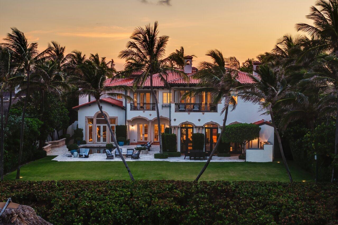 Discover 2367 S. Ocean Blvd Highland Beach, a one-of-a-kind oceanfront estate in the prestigious Byrd Beach section is set on 100 feet of direct ocean frontage with over 600 feet of depth to the water.  This estate spans over 12,400 living sqft, with more than 18,000 TSF. The main residence with a brand new roof offers five luxurious en-suite bedrooms, while a separate guest house with three bedrooms, three baths and a living area with kitchen and dual entrances provides the ultimate flexibility for today's contemporary lifestyle. Designed and built by Dan Swanson, this extraordinary property flawlessly merges timeless elegance with modern sophistication, creating a residence that epitomizes both comfort and grandeur. The first floor showcases breathtaking ocean views through all major rooms. The ocean facing living room is anchored by a beautifully crafted fireplace detailed millwork creating an ambience of coastal serenity. The chef's kitchen is equipped with custom cabinetry, two large islands, and top-tier appliances. Adjacent to the kitchen, the spacious loggia with summer kitchen and bar is framed by French doors, allowing an effortless transition between indoor and outdoor spaces, while providing an uninterrupted connection to the ocean's natural beauty.  Upstairs, the primary suite serves as a private retreat with his-and-her spa-like bathrooms, spacious walk-in closets, a sitting area with a fireplace, and a private balcony with stunning ocean views. The second floor also includes four additional en-suite bedrooms and a cozy sitting area. Outside, the lushly landscaped grounds feature a large oceanfront pool, a summer kitchen, and a Tiki Hut right on the sand. Additional amenities include impact windows, a five-car garage, motor court, elevator, and a full-house generator.. Just minutes from Atlantic Avenue, fine dining, and shopping, this estate offers the ultimate in coastal luxury living. Don't miss this rare opportunity to own one of Highland Beach's most extraordinary oceanfront estates.
