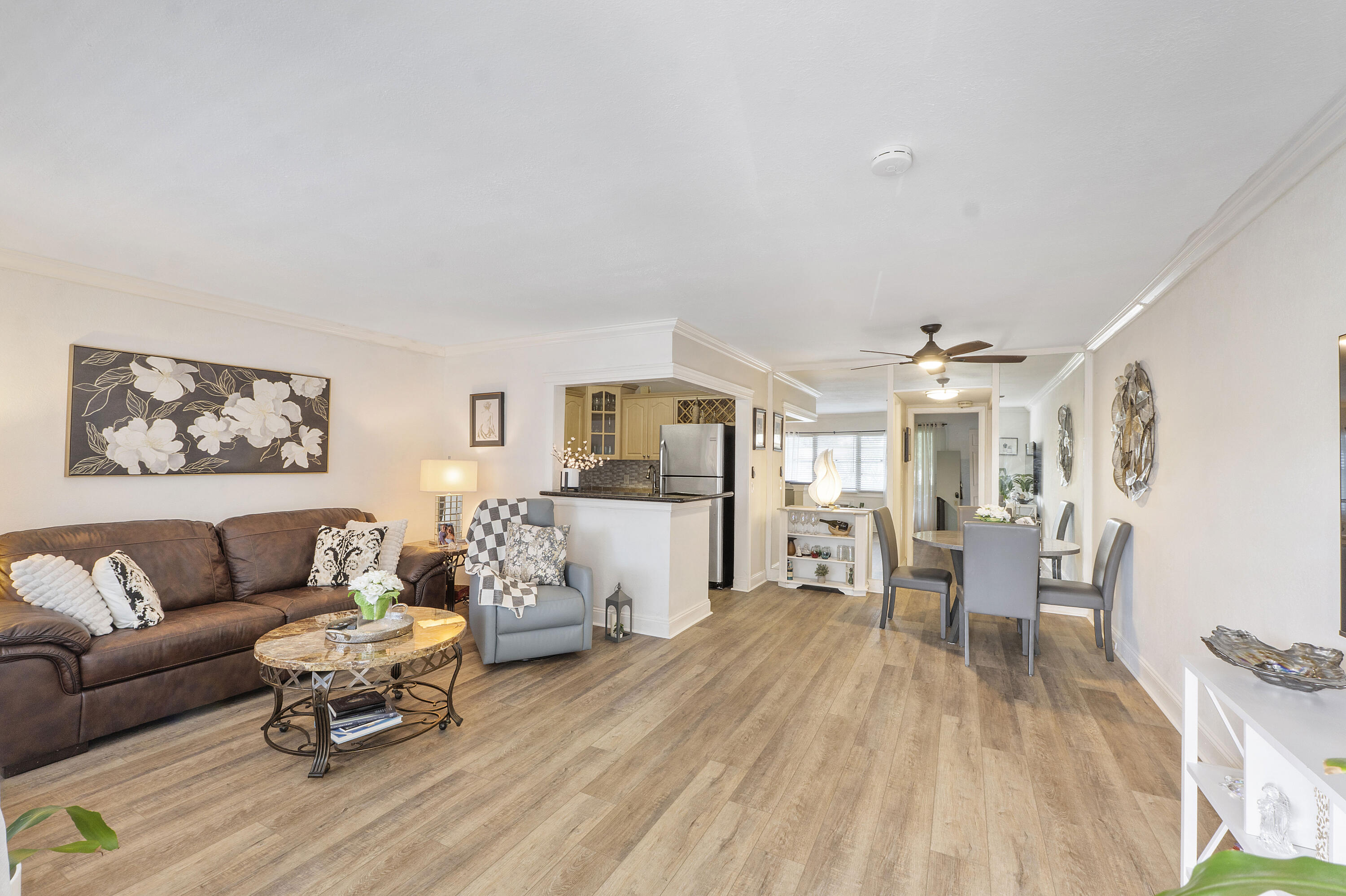 Beautifully reimagined and extremely well maintained 1 Bedroom . 1.5 Bathrooms residence in desirable Tilford at Century Village East, Deerfield Beach. The enclosed balcony with wall A/C extends the living space under air of this specific unit. Warm laminate flooring flows seamlessly throughout, complemented by custom kitchen cabinetry and tastefully fully renovated & modern full and half baths. Large double closet in main bedroom. Ideally located near the West Gate. Enjoy resort-style amenities including a grand clubhouse, pools, fitness center, tennis, pickleball, theater, courtesy shuttle, and endless activities. Big savings on electricity consumption due to the wall unit A/C's in both living spaces. Furniture negotiable with the right offer! Call listing agent today