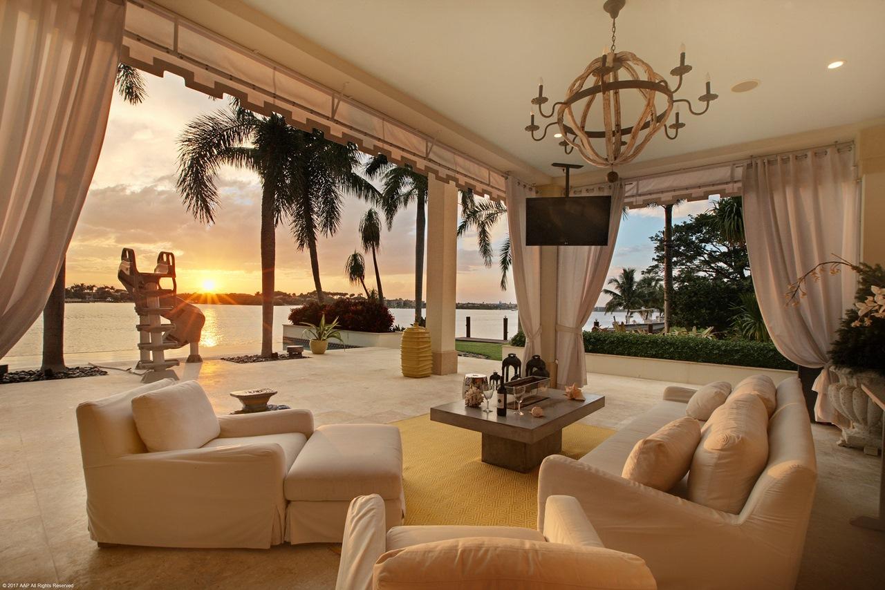 For the discrete homeowner seeking only the best in architectural design, spacious living and the finest in home construction and finishes, this may be the most spectacular estate home on the market. The ''Silver Prism Award'' winning 9,400 SF, 5 bedroom, 8.2 baths double point estate home provides you with 328' of water frontage and 140' of side protected yacht dockage, all within a very private gated compound on McCormick Mile in exclusive Ocean Ridge. Built to commercial specifications with a poured concrete second floor, the home has been impeccably maintained and recently remodeled, the owner is open to offering it furnished or unfurnished. Immediately upon stepping into the home through the arched outer doorway, your eyes are drawn to the beautiful Intracoastal water views seen across the large vanishing edge Infinity pool with Jacuzzi, as you mind's eye imagines the spectacular sunsets you'll be enjoying year around.
The home features marble and wood flooring, and the living room with its soaring coffered mahogany cathedral ceiling and fireplace is bathed in natural light through the extensive mahogany encased hurricane impact windows. The very large gourmet kitchen with its center-island and prep area features granite counter tops, incredible custom cabinetry and state of the art stainless steel appliances. Choose to take the elevator to the second floor or feel the strength and beauty as you climb the magnificent handmade wrought iron spiral staircase with gold leaf metals, designed by Avion Metal Works that soars up to the second floor. There you'll find the expansive master suite with wet bar and large sitting area offering magnificent water views. For him and her, there is a very large and unique custom master clothes closet usually seen only in the most exclusive architectural design magazines.
The list of amenities associated with this estate is almost endless and includes: a new home theater and media room; an exercise room with sauna and full bathroom; full home generator that provides automatic backup power; 4-car garage; state of the art security system; poolside covered lounge area as well as a covered patio with summer kitchen, and all surrounded by mature, lush landscaping.
This estate home is just a short walk from the beach and ownership includes membership to a private beach house. Access to some of south Florida's finest shopping and dining is just minutes from your private compound and living in Ocean Ridge also assures your privacy, security and peace of mind.