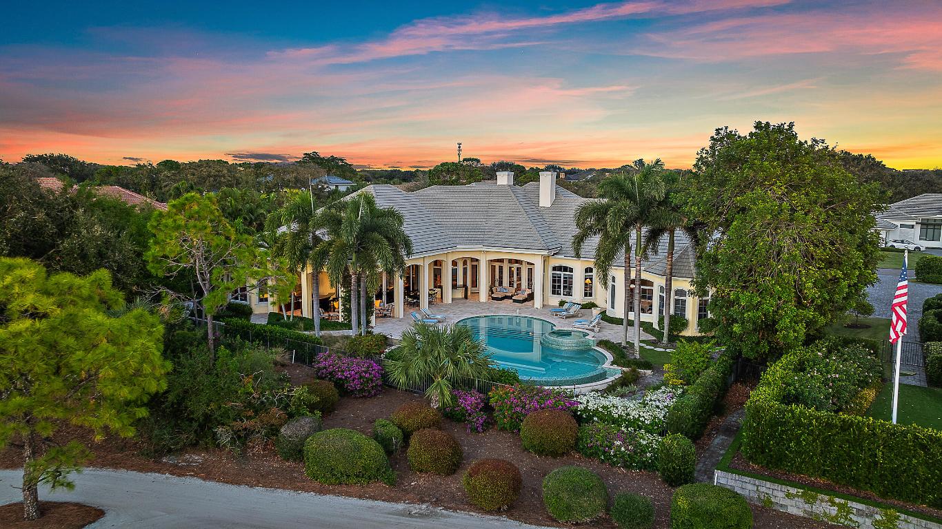 Nestled in the prestigious Jupiter Hills Village, this residence exemplifies the apex of luxury indoor-outdoor living. A custom-built estate, it stands as one of only eleven exclusive homes on the renowned Hills course, a golf course steeped in history, currently ranked 4th in the state and consistently in the Top 100 nationwide for over 3 decades. Designed for seamless entertaining, the outdoor bar and fireplace offer a welcoming retreat for year-round gatherings. Expansive windows and electronic sliding doors blur the boundaries between the family room, kitchen, and outdoor spaces, connecting effortlessly to the fireplace, bar, grill, and poolside terraces. For formal occasions, an elegant dining room, complete with an adjacent wet bar & new 200 bottle wine fridge in the cellar, elevates the experience of entertaining. The owner's wing is a haven of tranquility, featuring a private massage room, his-and-her baths, spacious walk-in closets, and a dedicated laundry room. Following a massage, step directly into the pool or jacuzzi for the ultimate relaxation. The main floor also includes two additional bedroom suites, and a large, beautifully paneled office. 
For extended-stay guests, an upstairs suite offers a bonus room and morning bar, providing a comfortable, private space. With over 7,000 square feet of air-conditioned living space, this residence meets the highest standards for those in search of elegance, functionality, and uncompromising quality.

Exterior highlighted features include; 9 separate electronic roll down screens & shutters, Doors In Motion double quad sliding doors off living/family room, new security system, Air conditioned 3-car garage with extra storage, generator (just serviced) with wifi capability, all impact windows/doors, 1,000 gallon propane tank, full home built-in surround sound, surge protection with lightning rods. 

Interior highlights include; Sub Zero refrigerator, 6-burner cooktop, 5 zone A/C (3 replaced in June of 2024), water purification system for entire home, primary bedroom includes his & her baths & large walk-in closets, dedicated laundry, massage room, & sitting/workout room. 

The exterior of the home boasts exceptional features, including nine electronic roll-down screens and shutters, Doors in Motion double quad sliding doors, a newly installed security system, and an air-conditioned three-car garage with additional storage. A recently serviced generator with WiFi capability, impact-rated windows and doors, a 1,000-gallon propane tank, full-home built-in surround sound, surge protection, and lightning rods further enhance its functionality and security.

Inside, the home features a Sub-Zero refrigerator, Wolf six-burner cooktop, and a five-zone A/C system, with three units replaced in June 2024. A whole-home water purification system ensures convenience, while the primary suite offers his-and-her baths, spacious walk-in closets, a dedicated laundry room, a massage room, and a sitting/workout area.