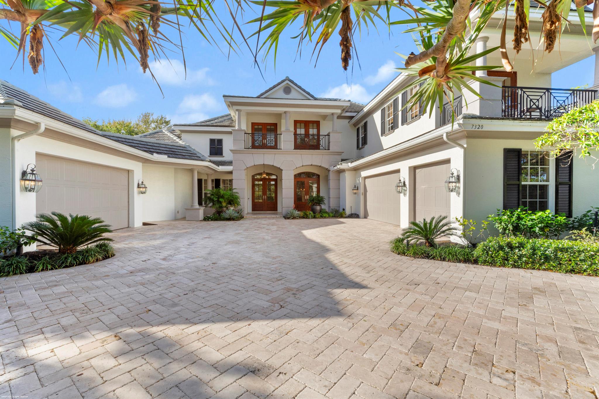 This stunning estate welcomes you through grand double mahogany doors into a space defined by soaring ceilings and vast windows that frame serene views of the pool, golf course, and nature preserve. Situated on a private half-acre lot, the home offers five  bedrooms, six full bathrooms, and two powder rooms. The second floor is a retreat of its own, boasting a movie theater and a game room perfect for entertaining. Thoughtfully designed for convenience and luxury, the residence includes two laundry rooms, an elevator, a summer kitchen, and multiple wet bars. A dedicated office provides a quiet space for work or study, while the five-car garage ensures ample storage and parking. This exceptional property seamlessly combines elegance, functionality, and breathtaking natural surroundings.