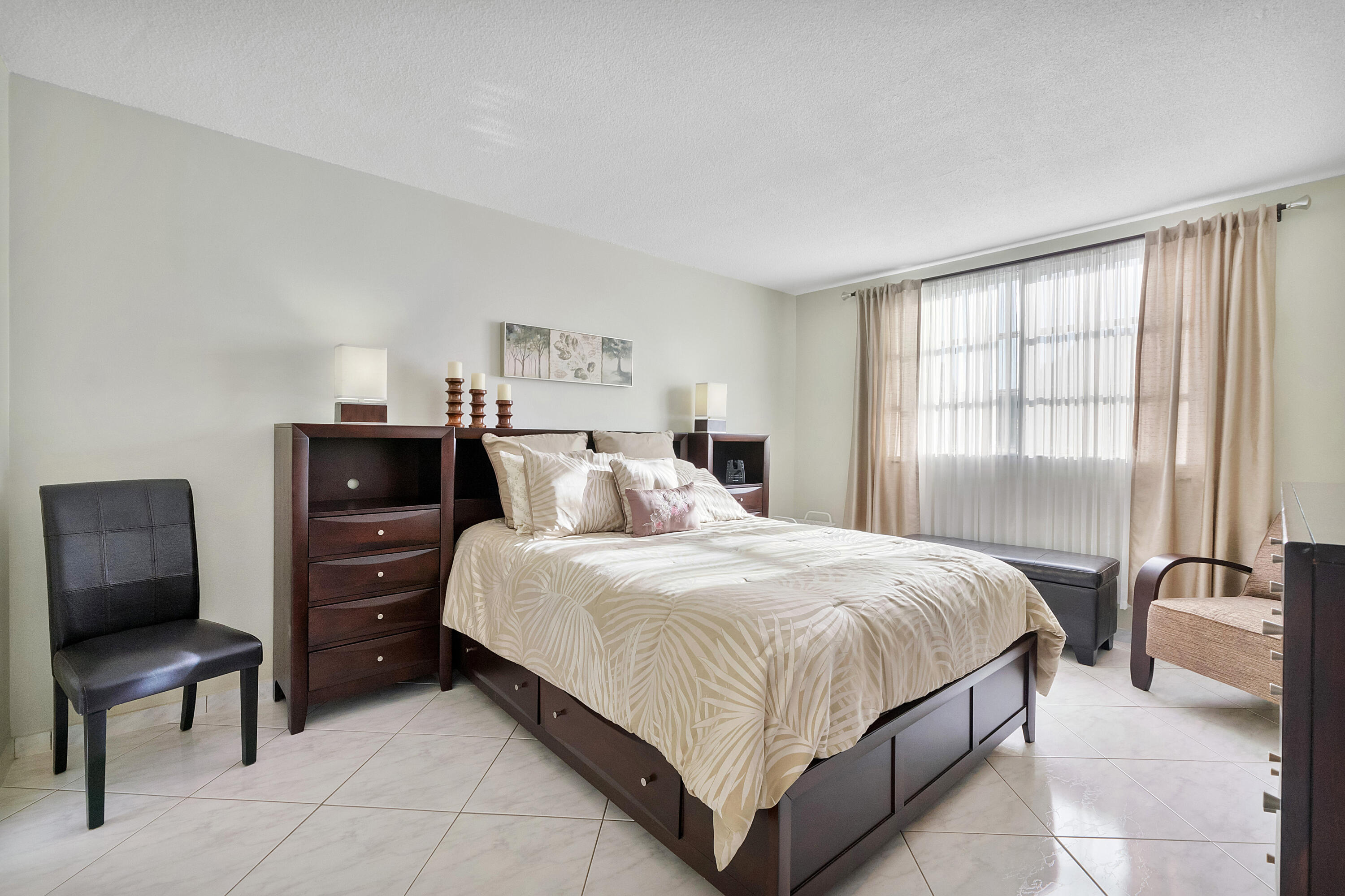 Nicely furnished third-floor one-bedroom with a pleasant water view. Tile flooring flows throughout the unit and extends into the Florida room, creating a more spacious feel. The generously sized bedroom offers direct access to the bathroom, which also features a separate entrance for guests. Ideally located in front of the pool and next to the clubhouse. Lauderdale Oaks offers a welcoming atmosphere with community amenities including fitness center, bocce, pickleball, shuffleboard, and three heated pools.