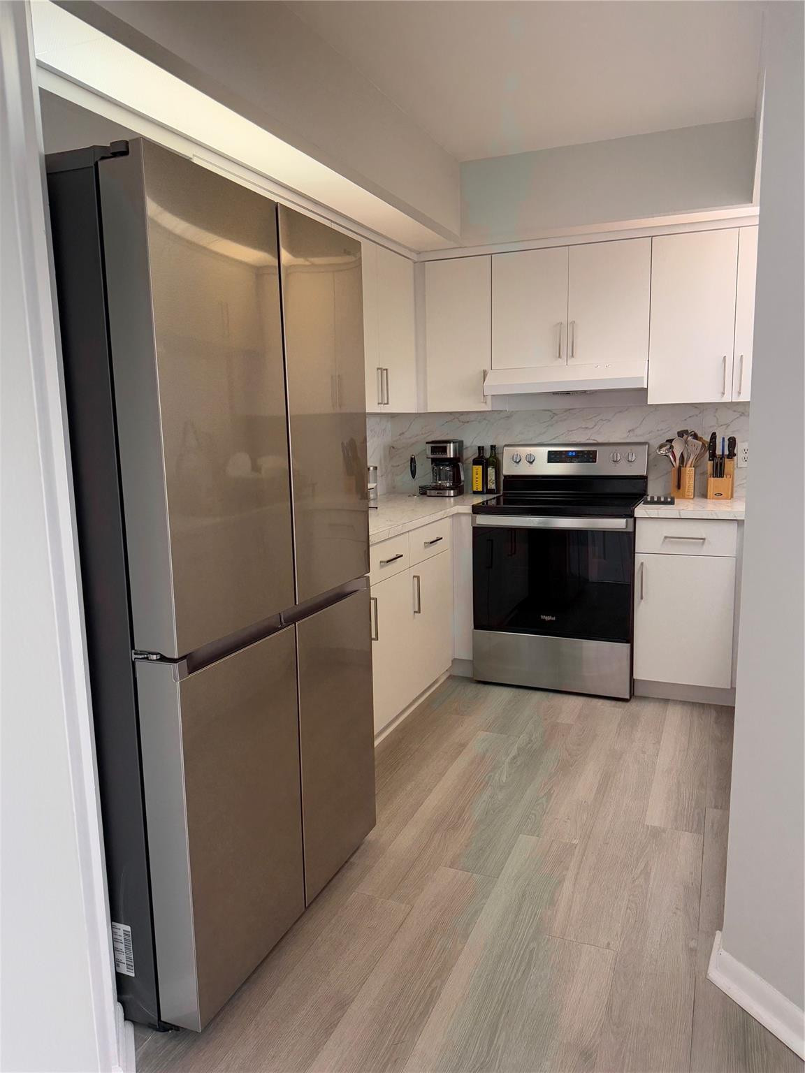 Welcome to this beautifully updated condo featuring modern finishes and an open layout! This 1 bedroom, 1 bath home offers stylish vinyl flooring throughout and a bright living and dining area perfect for entertaining. The fully renovated kitchen includes stainless steel appliances, quartz countertops, and sleek cabinetry. The spacious bedroom provides ample storage, while the bathroom has been tastefully updated. Enjoy the convenience of a brand new LG washer and dryer inside the unit, along with a private screened-in balcony offering tranquil views. Move-in ready and centrally located, this condo is ideal for investors!