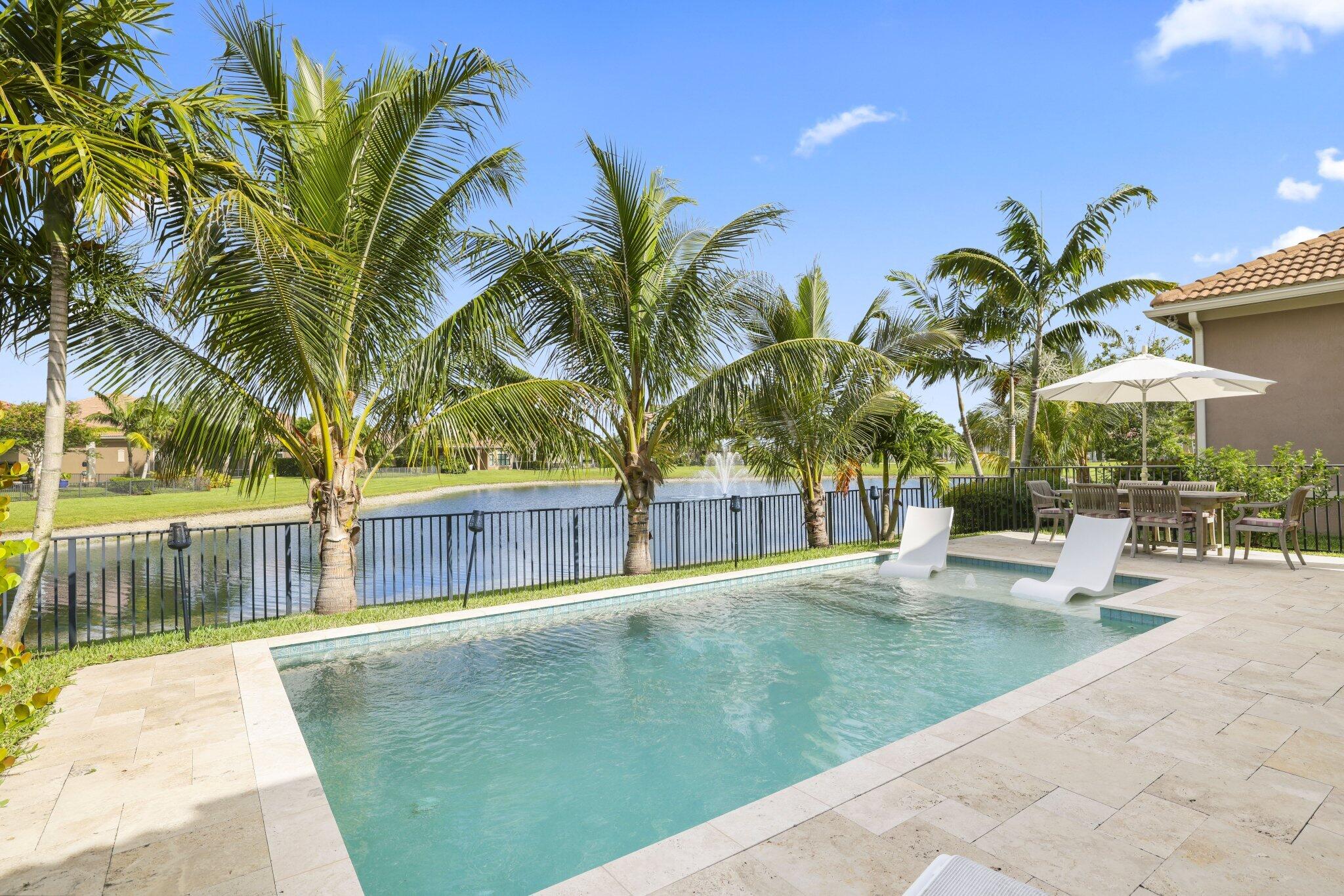 Stunning waterfront pool home in Four Seasons at Parkland, a premier 55+ community. This highly sought-after Azure model offers 3 bedrooms, 2.5 baths, modern design, and high-end finishes throughout. The gourmet kitchen opens to the spacious great room, where pocketing glass slider doors disappear into the wall to create a seamless indoor-outdoor living experience. Enjoy entertaining by the sparkling pool overlooking tranquil water views and spectacular sunsets. Resort-style living at its finest in one of Parkland's most desirable active adult communities.