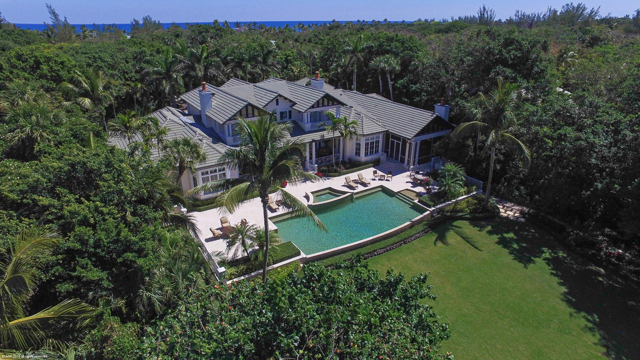 Enter down a long private drive canopied by old growth trees to this magnificent, British West Indies 2.6 acre private estate sitting directly on the Intracoastal with sweeping lawns and views across to a natural preserve. Built in 2008, it features outstanding finishes, superb millwork, high ceilings and includes 5 bedrooms with room to expand or build a separate guest house. The kitchen and butler's pantry include top of the line appliances plus there is a family room, game room, climate controlled wine room and first and second floor laundry rooms. Outside, there is a screened outdoor kitchen and dining area in addition to extensive open and covered areas surrounding the infinity edge pool and spa. A curving walkway to the dock is surrounded by lush tropical landscaping. Please note that some photos have been virtually staged.
