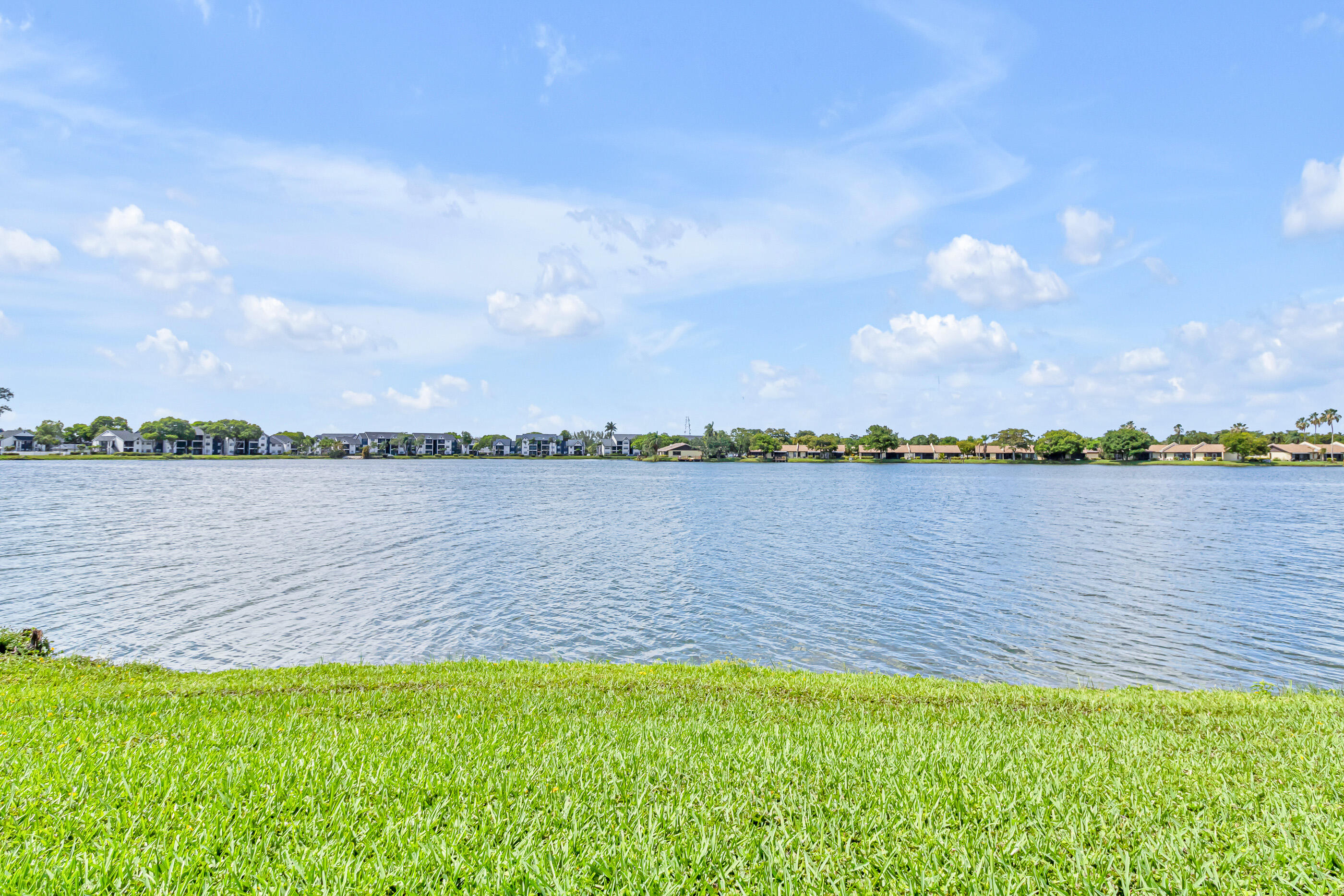 Welcome to this amazing slice of Florida Living.  This is a wonderful 2 bedroom 2 bath oasis with a stunning view of the lake - come take your morning coffee on the patio overlooking the lake.  This property has an updated guest bathroom and tile throughout the property and more importantly IMPACT SLIDING GLASS DOORS AND WINDOWS!! Moving in ready!!  The association has plenty of reserves so you only need 5% for the loan!! Come on down and let's make this happen!
