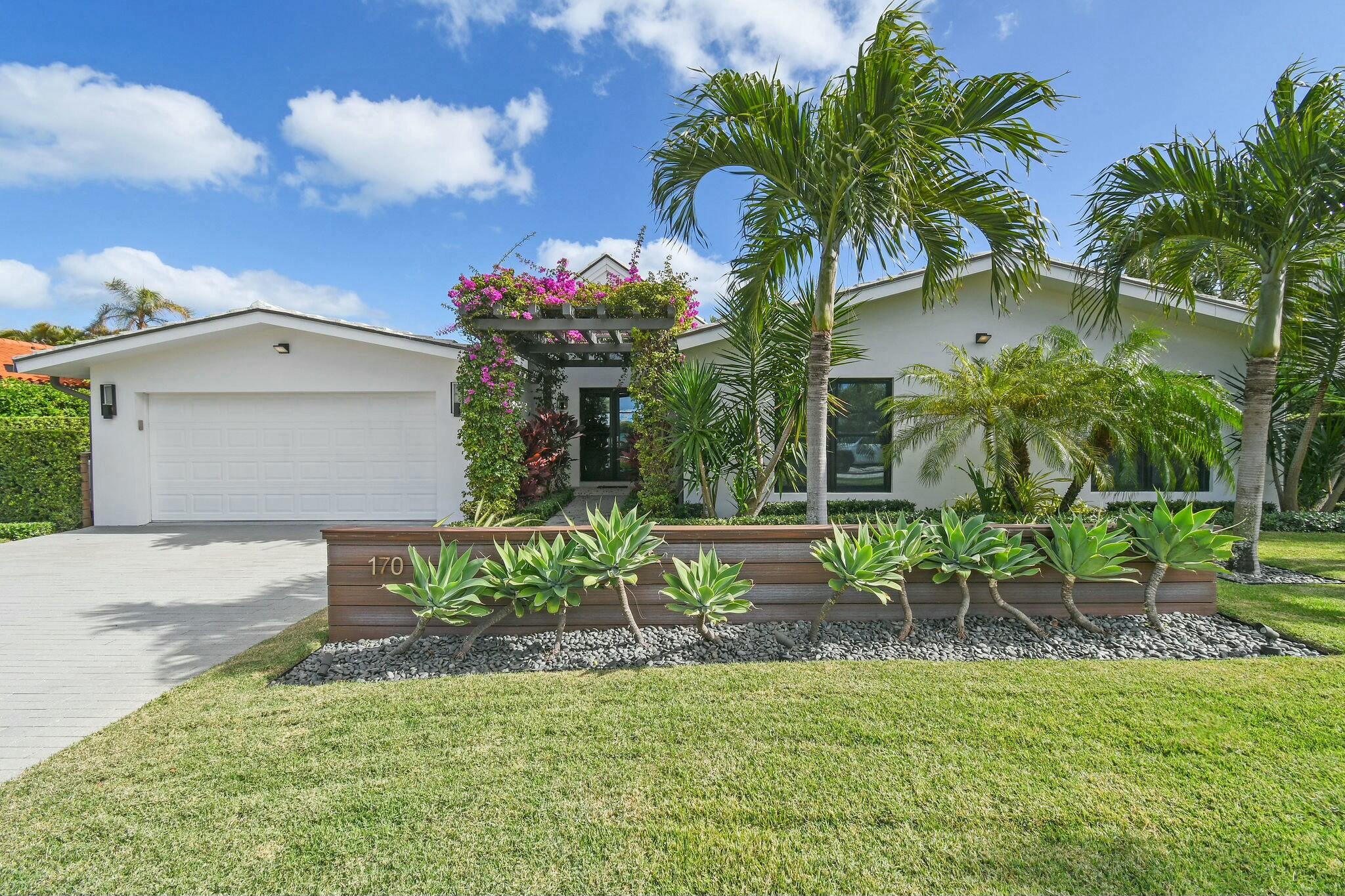 Welcome to your dream home, just steps from the beach in beautiful Jupiter Inlet Colony. This tastefully renovated 4-bedroom, 3.5-bathroom residence features a stunning bougainvillea-draped atrium entrance, setting the tone for the tropical oasis within. Inside, the wide-open living space impresses with soaring volume ceilings, gleaming marble floors, and an abundance of natural light. The heart of the home is the open chef's kitchen, complete with a wine cooler, oversized counters, and high-end finishes—ideal for entertaining or quiet family evenings. The primary suite offers a tranquil retreat, featuring custom doors that open to your own private garden. Indulge in the luxurious Zen- inspired spa bathroom, boasting a freestanding tub, sleek finishes, and Kolbe impact windows for style and safety. Step outside to enjoy the sparkling pool, surrounded by lush, tropical landscaping that offers both beauty and privacy. 170 Beacon Lane embodies the Florida lifestyle, with every detail designed for comfort and sophistication. Don't miss this opportunity to live in Jupiter Inlet Colony, where the beach, beauty, and convenience come together in perfect harmony.