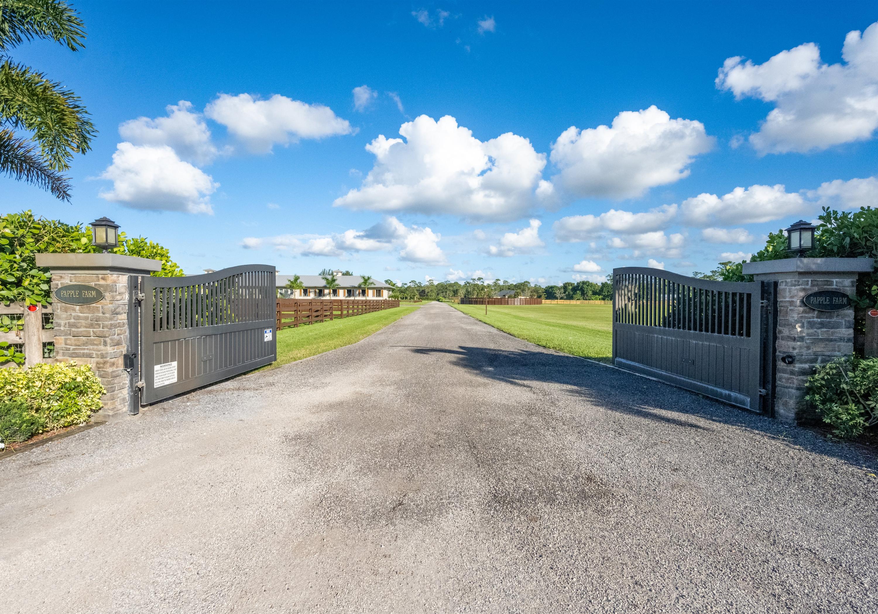 Offered for the first time, Papple Farm is a 15 acre equestrian oasis. Located near the Publix Plaza, Palm Beach State College and Southern Blvd it is only a 10 minute drive to the Winter Equestrian Festival & Global Dressage Festival show grounds. No expense was spared in the development and construction of this equestrian compound with a new, large, well designed home. It has a high end kitchen overlooking the beautiful irrigated grass field with the arena and barn beyond it. The view of the arena and 20 stall barn are spectacular from the kitchen and sweeping veranda. It is the perfect place for morning coffee or the evening sunset. The home has a design that is traditional southern but with a modern farmhouse vibe. The 20 stall barn is CBC construction with an airy & breezy feel with high ceilings. The wide aisles offer plenty of space for placing tack trunks outside each stall, or place in one of two tack rooms. There are wall to wall mats, integrated fly spray system, 4 large grooming stalls, 2 wash stalls, extra large washer and dryer in the laundry room, a kitchen, bathroom, feed room, hay room, a separate covered manure bin with a fly spray system and roll up door, 2 RV hookups, and a separate 3 bedroom 3 bathroom CBC grooms quarters with a common kitchen. The entire property is on 3 - RO systems to ensure clean filtered water for horses and humans. (a 1000 gallon system for the house and 2 - 1000 gallon systems for the barn and grooms quarters). There is a substantial machine shed to house all the things that need storing in the off months. With 3 large roll-up doors you can store virtually anything big such as a boat, horse trailers or RV. There is plenty of room for a covered arena, more paddocks, or another barn. Or just enjoy living on this expansive land on this beautiful property as is and generate positive cash flow. The arena is truly all-weather. You can ride immediately after a drenching rain. No wetland, no easement , no ponds, and no power lines. The property drains extremely well to canals on each side. You can expand the facilities for more revenue if desired. You could also add a guest house or property managers home. This property has it all and can be enjoyed as a beautiful private farm and home, or expanded for an even bigger equestrian operation. Truly a must see property!!