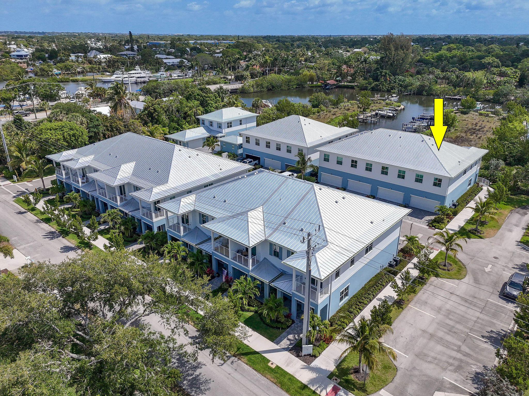 Motivated Seller! Experience the ultimate Florida lifestyle in this stunning waterfront coastal-inspired end-unit townhome featuring 3 bedrooms, 2.5 baths, a 2-car garage, and a deeded private dock with a 10,000-lb. boat lift included. Enjoy water views and bright southern exposure from this upgraded CBS home with impact glass windows and doors. The open-concept layout features soaring ceilings, abundant natural light, quartz countertops, custom cabinetry, designer tile, wide-plank vinyl flooring, frameless glass showers, a custom wine bar with a 150-bottle dual-zone wine refrigerator, and a professionally designed walk-in pantry. Step outside for easy boating access, peaceful sunrises,  wildlife, or relax by the community pool. This home offers luxury, comfort, and waterfront living.