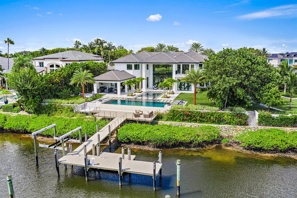 Modern sleek design with dramatic open spaces, soaring ceilings and water views from almost every room. This completely renovated home located in the prestigious Admirals Cove with 110 feet water frontage that can accommodate a 80 foot boat. Resort styled back yard with an expansive covered porch, full summer kitchen, Euro edge infinity pool & spa, fire pit, expanded dock. The home boasts 10,235 square feet under air with 5 en suite bedrooms, Hurricane Impact windows and doors, 2 master suites on the first floor with custom walk-in closets. Gourmet chef's kitchen custom cabinetry and top-of-the-line appliances including  Gas Wolf stove, double oven, Subzero refrigerator, and oversized pantry.  See supplemental... Required golf membership purchase conveys all the first class amenities of Admirals Cove including two spectacular clubhouses, 45 holes of golf, 5 restaurants, 63 slip marina with floating docks, Yacht Club, 13 har-tru tennis courts, state of the art fitness, brand new spa, salon and men's barber shop, and kids club.