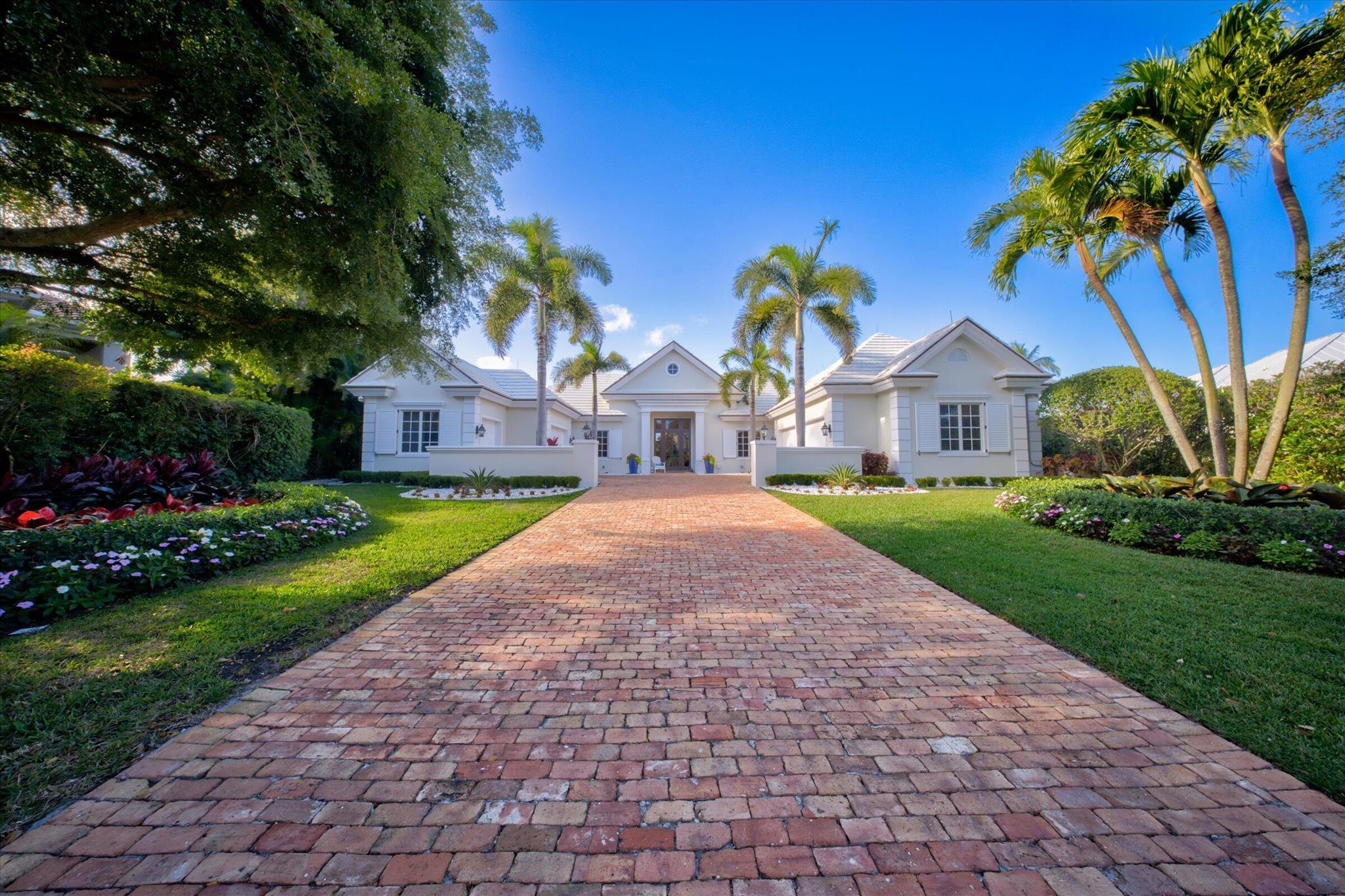 This stunning John McDonald-built estate has been fully remodeled with luxury and modern elegance. The new chef's kitchen features a massive marble island, Wolf 8-burner gas stove, Wolf microwave, Thermador refrigerator/freezer, and a wine fridge. The primary suite boasts a Kohler dual-head shower and a Sunlighten infrared spa. Updated living spaces include new electronics, a gas fireplace, and an executive office with built-ins. Outdoors, enjoy a private pool, sauna, accent-lit landscaping, and a web-enabled irrigation system. A whole-home Generac generator and 2017 roof provide peace of mind. Beyond its exquisite first impressions, this fully remodeled custom home offers an unparalleled blend of sophistication and comfort. The chef's kitchen is a masterpiece, featuring brand-new cabinetry, a spacious marble island, and high-end appliances, including an 8-burner Wolf gas stove with a professional-grade dual-fan hood, a Wolf microwave, a Thermador refrigerator and freezer, and a wine refrigerator.
The primary suite is a private retreat, showcasing a luxurious Kohler dual-head shower and a state-of-the-art Sunlighten infrared spa. The additional bathrooms and powder room have been completely updated with new sinks and toilets, reflecting modern elegance.
Designed for both entertainment and everyday living, the home boasts a refined yet comfortable atmosphere in its updated living and family rooms. A gas fireplace adds warmth to the space, while a newly installed, high-tech sound and electronics system enhances the experience. The executive home office is thoughtfully designed with built-in file cabinets, a custom desk, and a widescreen TVperfect for remote work.
Step outside to a private backyard oasis, featuring a sparkling pool, a serene sauna, and lush, newly redesigned landscaping. The outdoor space is beautifully illuminated with accent lighting on the palm trees, while a web-enabled irrigation system ensures effortless maintenance.
Additional upgrades include a whole-home Generac generator for reliable backup power and a well-maintained roof, installed in 2017, offering long-term durability. This remarkable home in the prestigious Loxahatchee Club seamlessly combines luxury, functionality, and timeless appeal.
Don't miss this rare opportunity to own a truly exceptional residence in one of Jupiter's most sought-after communities!