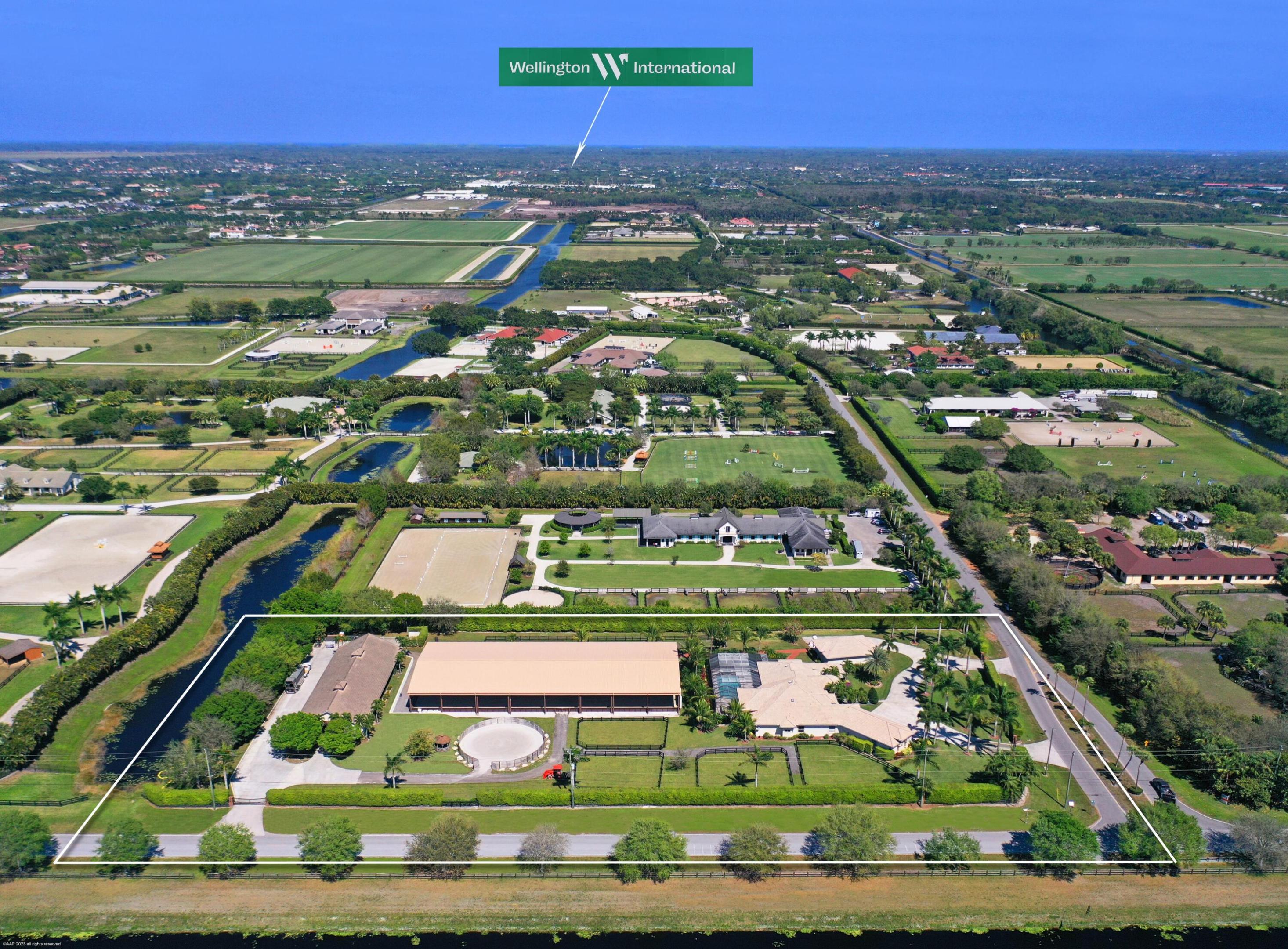 Sprawling 5 acre farm with a NEW COVERED ARENA!   Located within hacking distance to the show grounds, this equestrian estate includes an over 4,500 sq ft main house and a 12 stall center aisle barn with 2 grooms quarters, tack and feed rooms, multiple wash stalls, a 85x200 ft NEW covered arena with mirrors, a new round pen and 6 paddocks. The barn is finished with tongue and groove, shutters & roll-down doors. Separate barn entrance and parking, along with an impressive house entry with 2 gates. The well constructed main house recently had an over the top renovation completed, and the new floor plan and new high-end finishes has created an open and inviting space perfect for entertaining. It boasts 5 bedroom and 6 bath with office and 6 car garage.
The designer kitchen has double ovens, double dishwashers and stainless steel sub-zero, Thermador range and appliances.
 This magnificent home offers high ceilings, heavy moldings, new hardwood floors, new impact sliding doors that opens up to an over 3,000 sq ft screened-in outdoor area with a large saltwater pool and outdoor shower. There is also a separate carriage house for storage or additional stalls. Don't miss out on this unique offering.