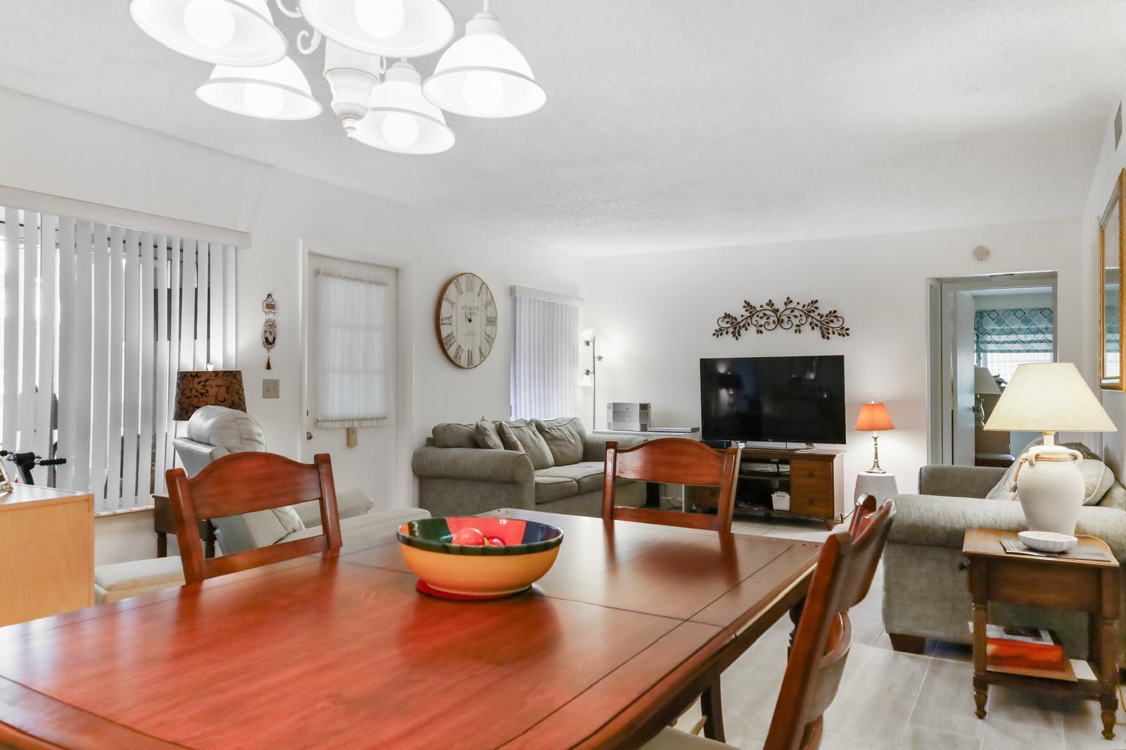 Welcome to this beautifully maintained 2-bedroom, 2-bathroom first-floor apartment, where comfort, convenience, and easy Florida living come together. Located in a desirable and well-maintained 55+ community, this move-in-ready home is perfect for year-round living or as a seasonal retreat. Start your mornings or unwind in the evenings on the inviting front porch, enclosed with both screens and glass, allowing you to enjoy the space in every season. Inside, you'll appreciate the elegant ceramic tile flooring throughout the entire home—including both bedrooms—with no carpet, offering a clean, modern look and effortless maintenance. The spacious floor plan includes a full-size washer and dryer inside the unit for everyday convenience. Both bathrooms have been tastefully updated. finishes, adding style and functionality.  Enjoy added peace of mind with major recent upgrades, including a new roof 2024 and a new water heater, while hurricane shutters provide extra protection during storm season. This charming condo offers the perfect combination of comfort, value, and low-maintenance living in a welcoming community. Don't miss the opportunity to make it your own! "All information is deemed reliable but not guaranteed. Buyer and Buyer's Agent are responsible for verifying all measurements, dimensions, HOA information, restrictions, fees, and any other information deemed important to the Buyer."