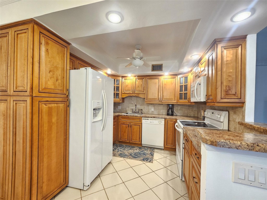 REDUCED TO SELL!! COMPLETELY UPDATED 2BEDS/ 2 BATHS 2ND FLOOR CONOD. SPACIOUS 1000 FEET. UPDATED OPEN KITCHEN, WOOD CABINETS. LOTS OF STORAGE PULL OUT DRAWERS PANTRY. TILE BACKSPLASH. RECESS LIGHTING. TILE & LAMINATE FLOORING. 2 UPDATED BATHROOMS. MARBLE FLOORING & WALLS. UPDATED VANITIES & TOILETS. SPACIOUS MASTER BEDROOM W/ LARGE WALK-IN CLOSET. NEW ELECTRICAL PANEL. WATER HEATER 2022. A/C FEW YEARS. FURNISHED READY TO MOVE IN. SPACIOUS 8 FOOT SCREENED PATIO OVERLOOKING A RELAXING GARDEN VIEW SOON TO BE CENTRAL PARK. WELL MAINTAINED BUILDING W/ BBQ & SITTING AREA. ENJOY CENTURY VILLAGE ACTIVE 55+ RESORT STYLE LIVING. MANY ACTIVITIES & ACTIVITIES INCLUDING BUS SERVICE, CLUBHOUSE, TENNIS, BILLIARD, GYM, & MUCH MORE. LOCATED MINUTES TO BEACH , RESTAURANTS & SHOPPING. NO RENTAL  MUST SEE!