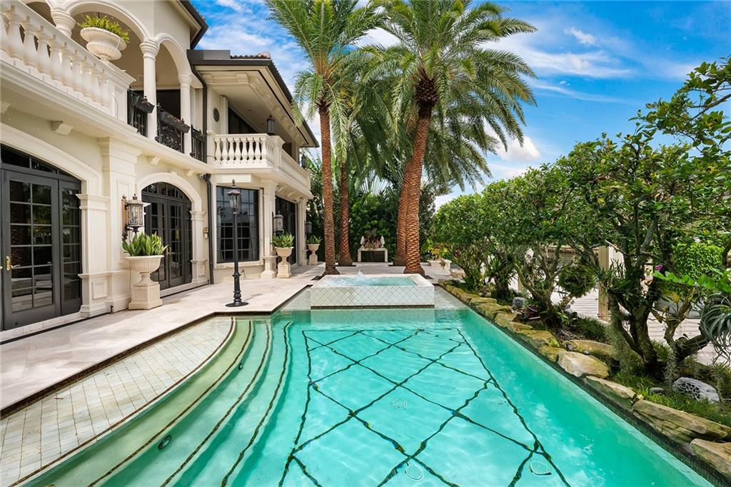 Rio Vista Isles - STUNNING European-inspired estate on one of the best 75’ WF lots on the wide part of the waterway w/no rear-facing homes across the canal!Spectacular architectural renovation in 2011 of this grand residence offers a sumptuous primary suite with His/Her master bath,fabulous views from the private & serene upper floor loggia w/custom gas fireplace which overlooks the heated pool w/flowing waterfalls & spa! EXQUISITE custom millwork & high ceilings throughout;3 spacious ensuite guest bedrooms w/walk in closets; ground floor formal office;custom staircase w/wrought iron railings;gorgeous onyx full entertainment bar;cabana bath;speaker system,laundry RM;2 car garage,exterior lighting,full house generator,hurricane protection, surveillance system,gated drive & pedestrian​​‌​​​​‌​‌​​​‌‌​​​‌‌‌​​‌​​‌‌​​​​ entry.